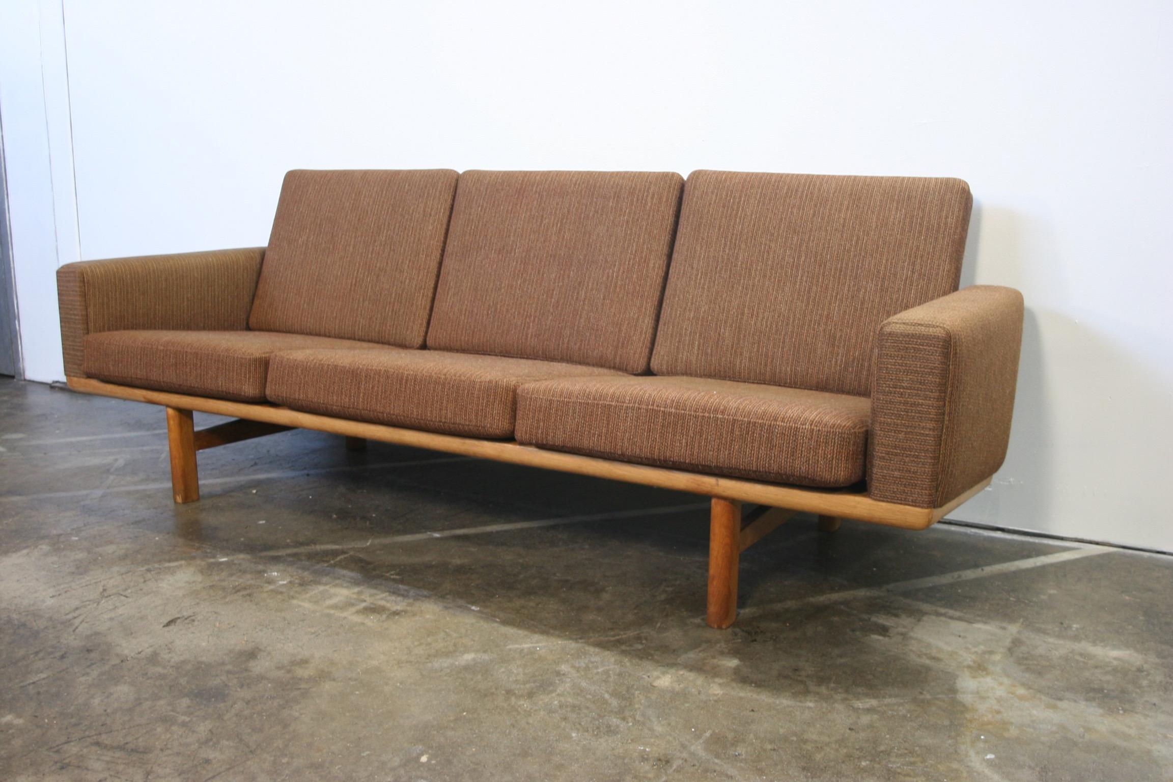 Vintage 1960s Danish three-seat sofa model GE236/3 designed by Hans Wegner for GETAMA Manufacturer solid light oak solid wood frame with original patina has original spring loaded cushions with original medium brown woven wool upholstery in great