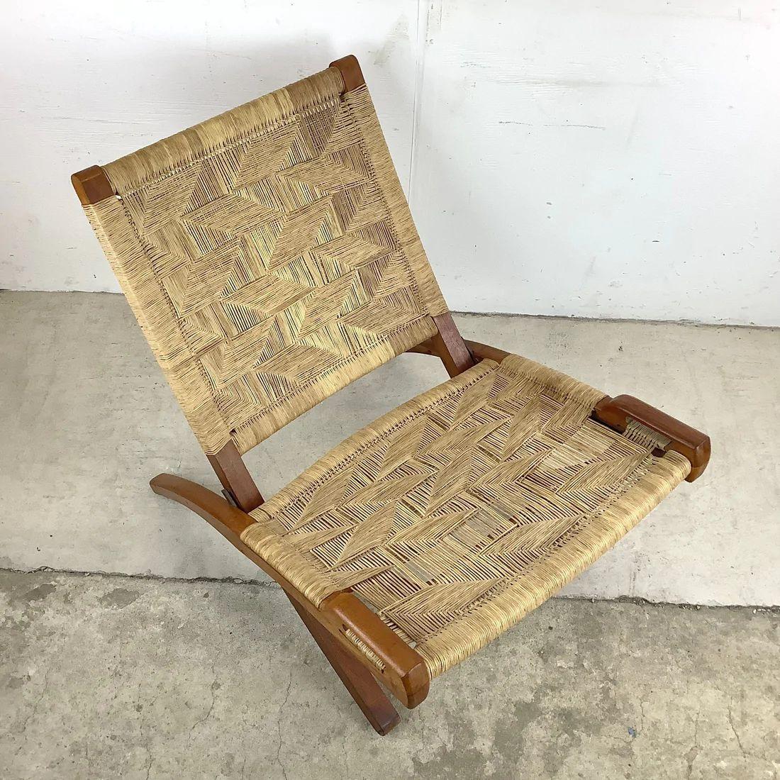 The unique Mid-Century Modern design of this vintage folding rope chair combines quality construction with comfortable proportions to make for a sturdy slipper chair perfect for regular or occasional use. Scandinavian Modern style similar to the