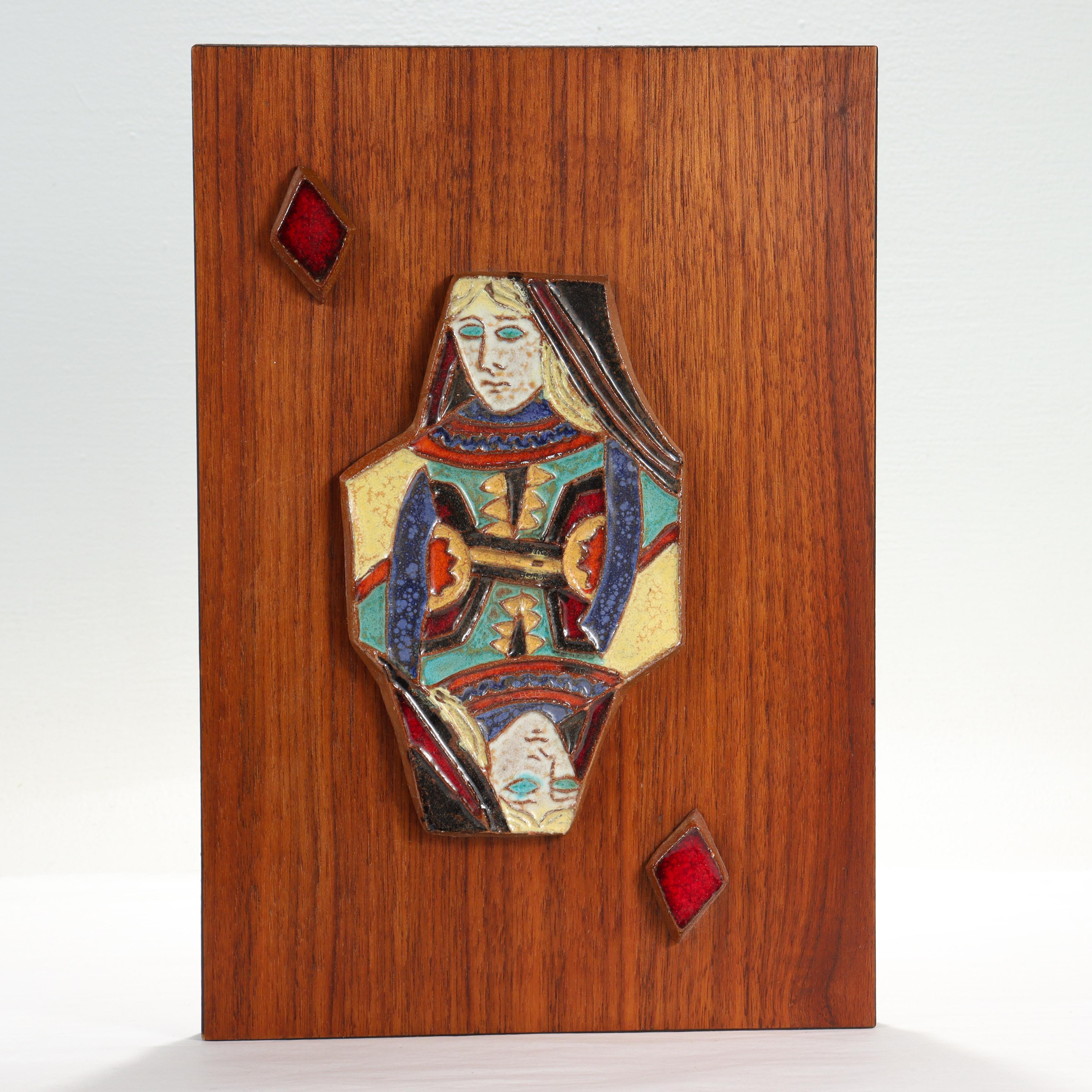 A fine Mid-Century Modern pottery tile.

By Harris Strong. 

With a terracotta pottery tile depicting the Queen of Diamonds mounted on a teak veneered panel.

Simply a great tile for any fan of card games!

Date:
Mid-20th century

Overall