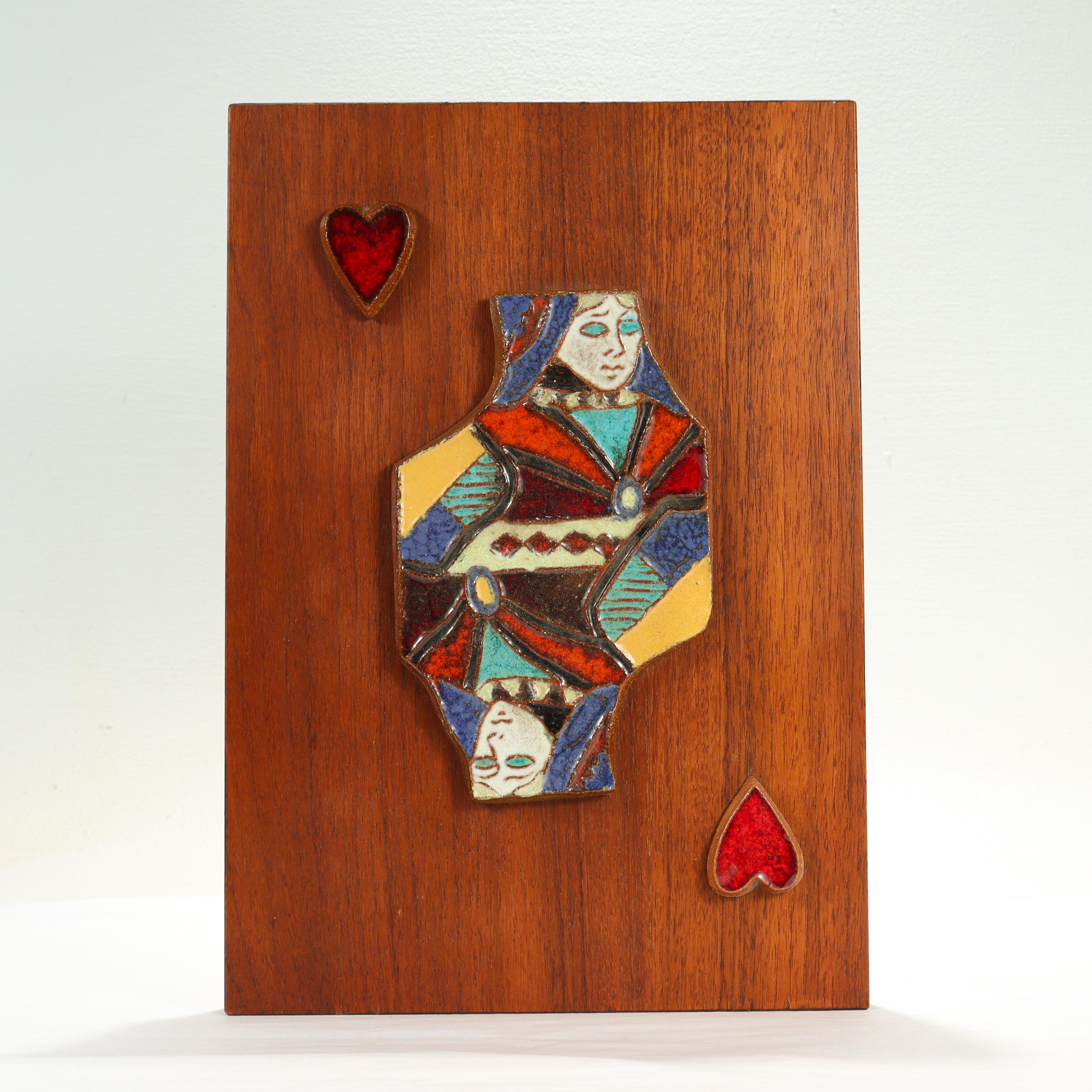 A fine Mid-Century Modern pottery tile.

By Harris Strong. 

With a terracotta pottery tile depicting the Queen of Hearts mounted on a teak veneered panel.

Simply a great piece for any mid-century room!

Date:
Mid-20th century

Overall
