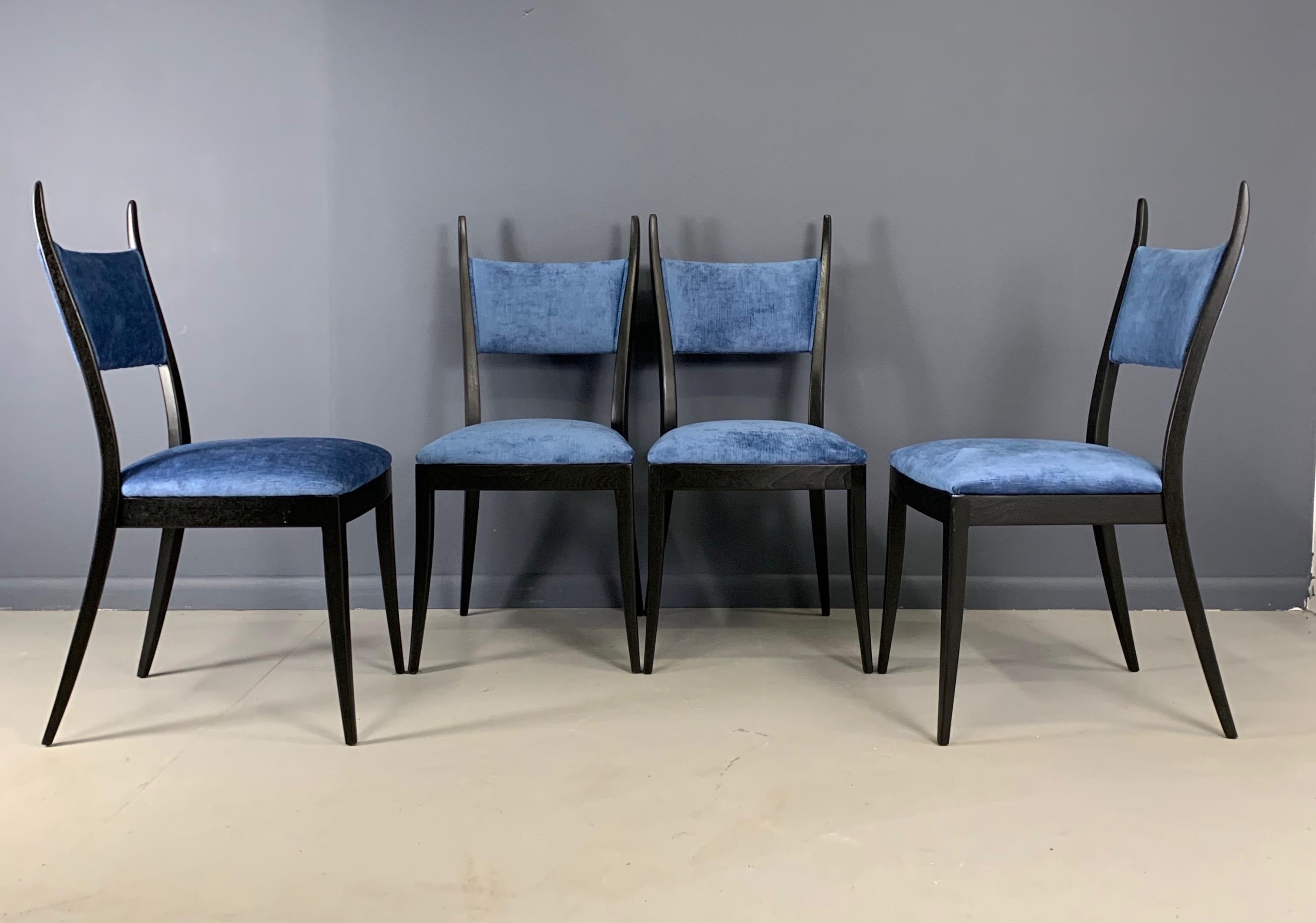 Incredible and interesting set of dining chairs, ebonized and upholstered in an azure velvet makes a gorgeous combination. The horn shape of these chairs is unique and distinctive. 

These chairs by to Harvey Probber have been totally refinished