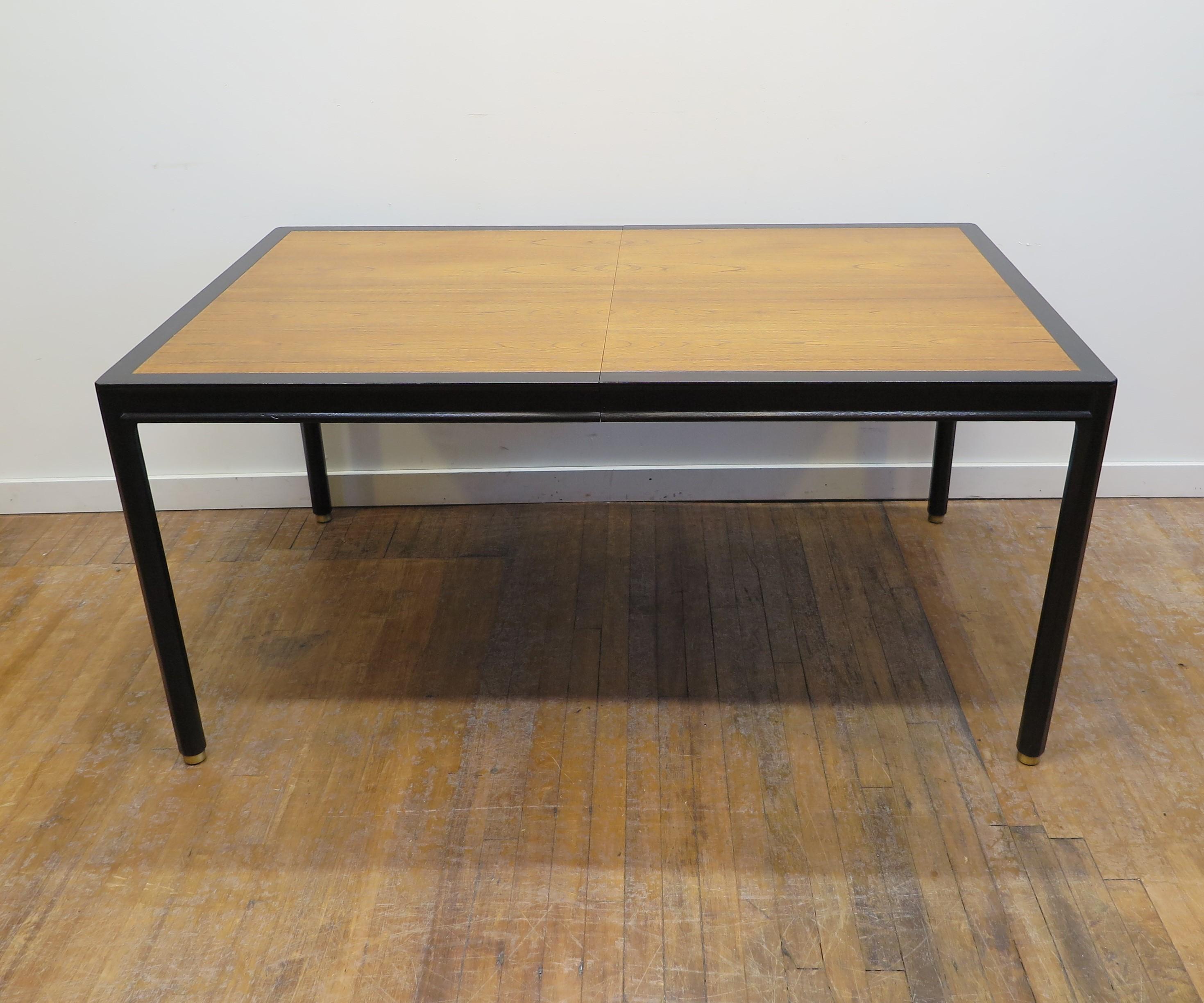Mid-Century Modern dinning table by Harvey Probber. Harvey Probber dinning table ebonized Mahogany frame with book-matched Walnut top. Having five Legs with brass detail surrounds on feet. Stunning extension table when closed is 60 inches. Three