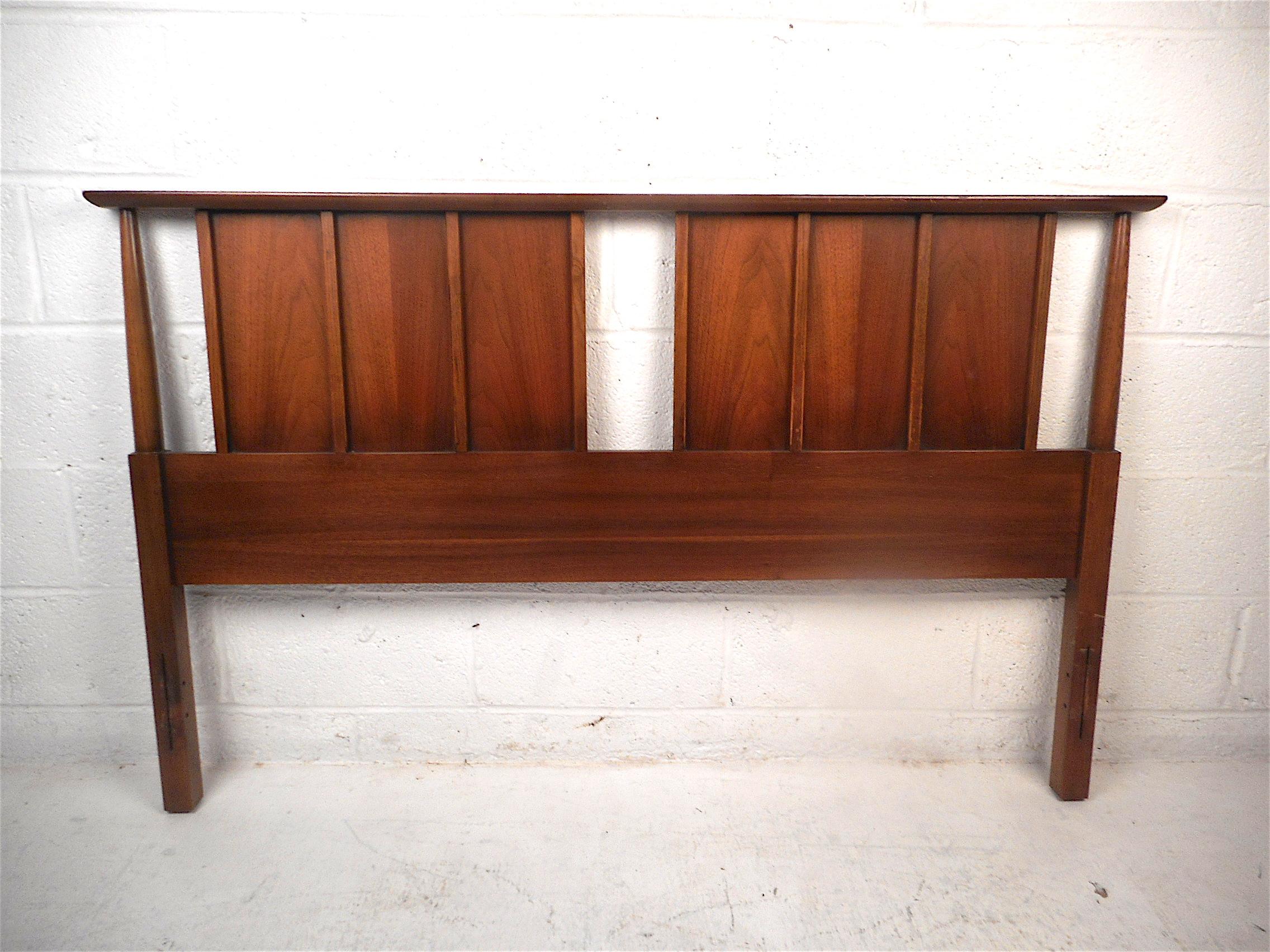 Stylish midcentury headboard and footboard. Sturdy construction with a dark walnut finish. Stylish tapered supports and vertical accents on the headboard. Great set sure to be a great addition to any modern interior. Rails not included. Made for a