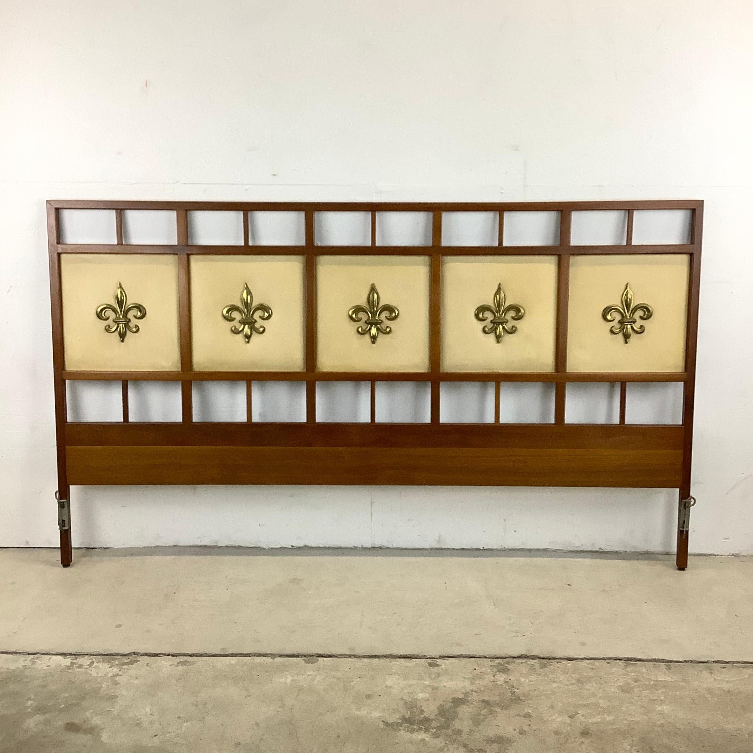 This eye-catching Mid-Century Modern headboard features a bold mixture of walnut wood finish and decorative fronts with brass fleur de lis details. The impressive Size of this king Size headboard by Gerry Zanck for Gregori makes a striking