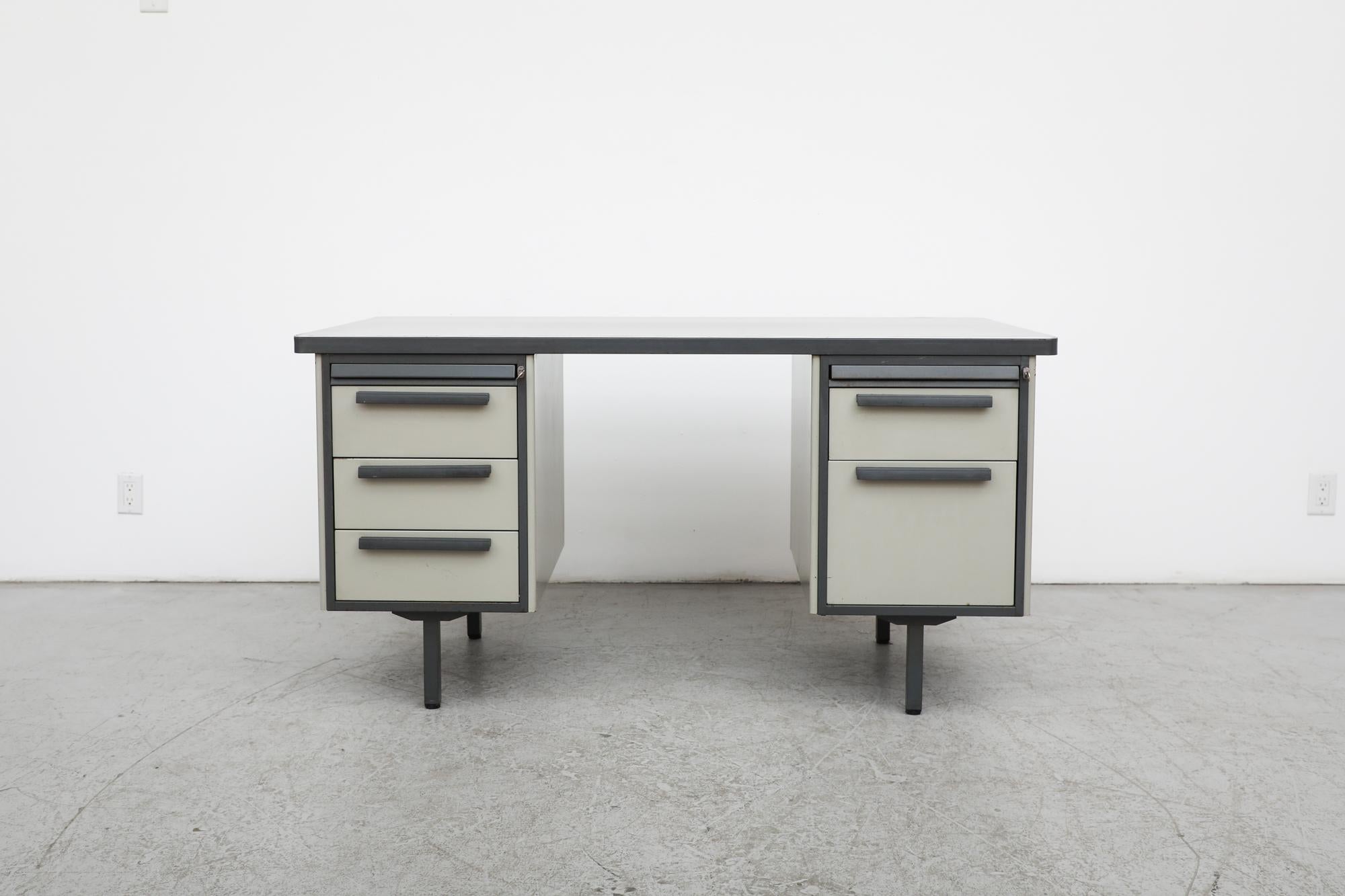 Mid-Century, Strafor manufactured desk from the Netherlands, 1960s. The desk's frame has cabinets on both sides with a file drawer on the right hand side. Outfitted with a linoleum top. In original condition with visible wear consistent with its age