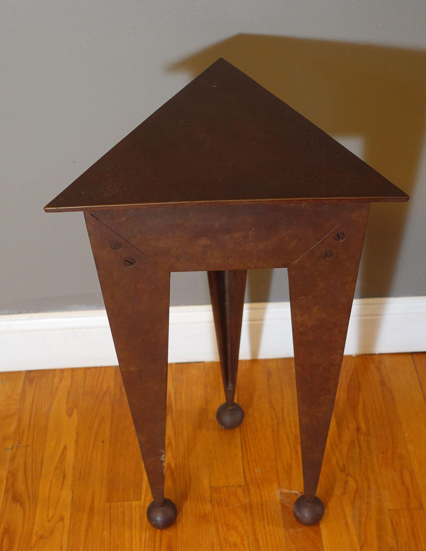 This is a heavy steel side table with a lifted top and a compartment under it.
A unique piece from the mid-century, very unusual form the era.
