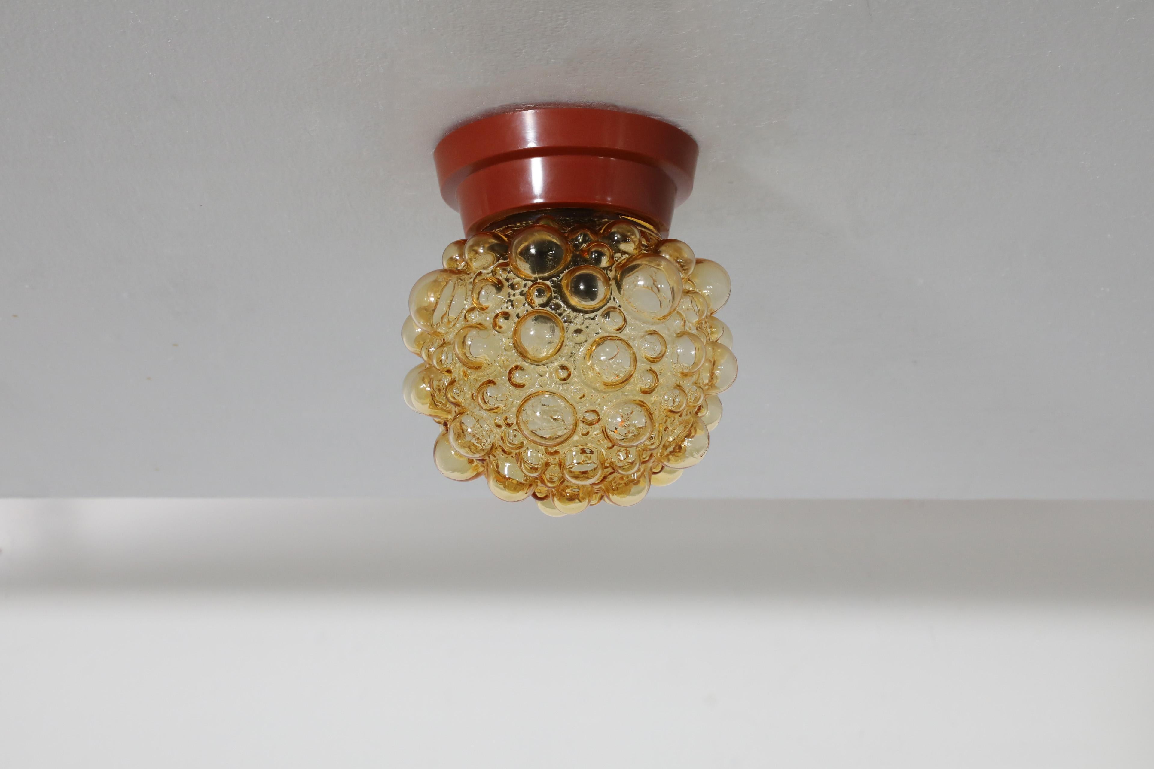Mid-Century ceiling or wall light with amber bubble globe by Helena Tynell for Glashütte Limburg, 1940's-1950's. Stylish and funky this versatile light adds a unique touch wherever its placed. In original condition with visible wear consistent with