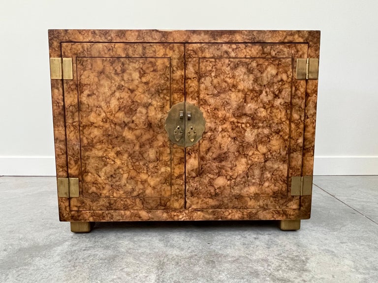 Pair of Mid-Century Modern Henredon Asian contemporary style faux tortoise painted two door cabinets with brass hardware, circa late 20th century. Each piece is hand painted and no two are exactly alike.