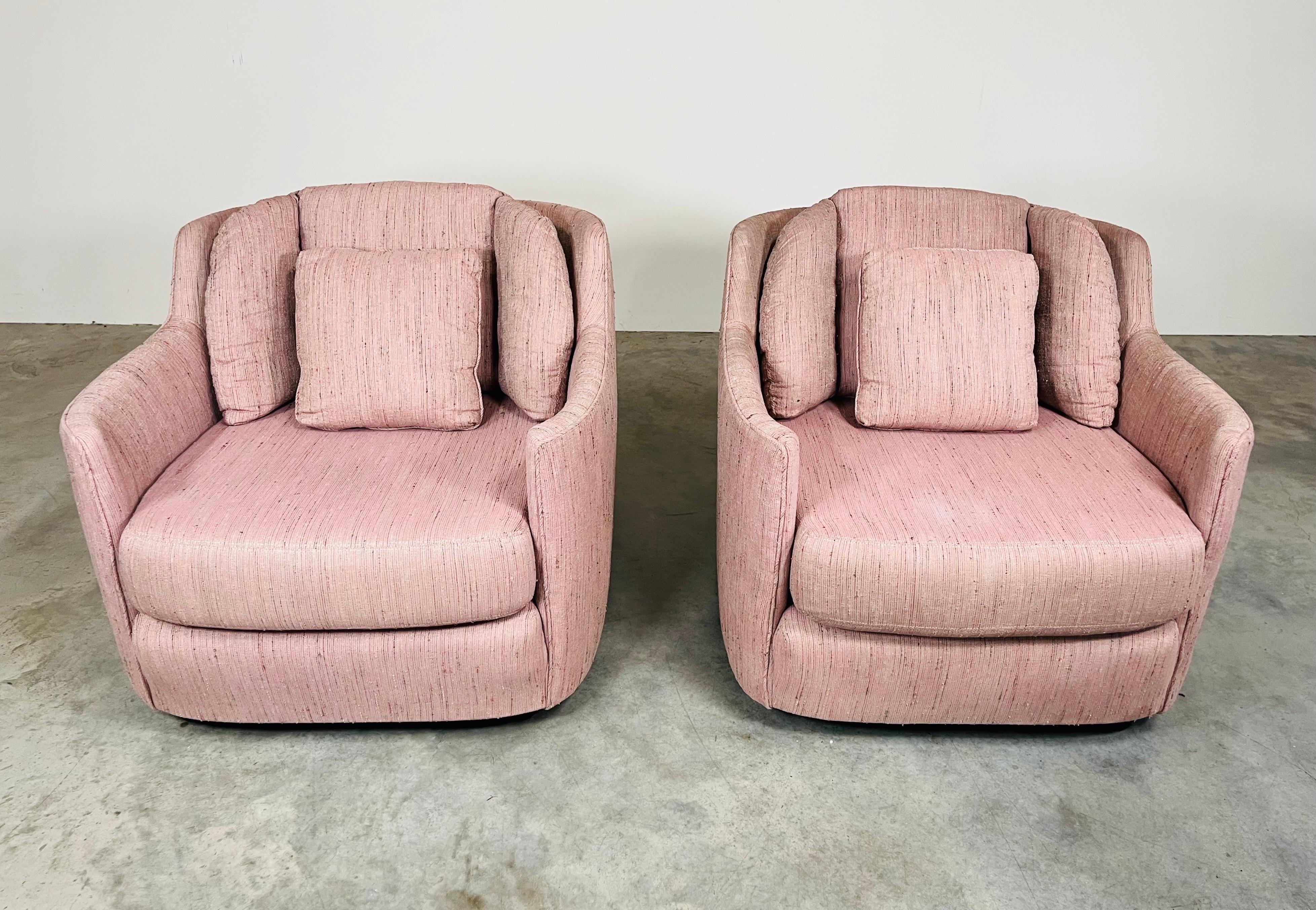 A cosy and incredibly comfortable pair of Henredon Folio 500 Club Chairs over ball casters having sculptural frames with steel strap suspension for extra sitting space and comfort along with deep seat cushions under bolstered backrest cushions that