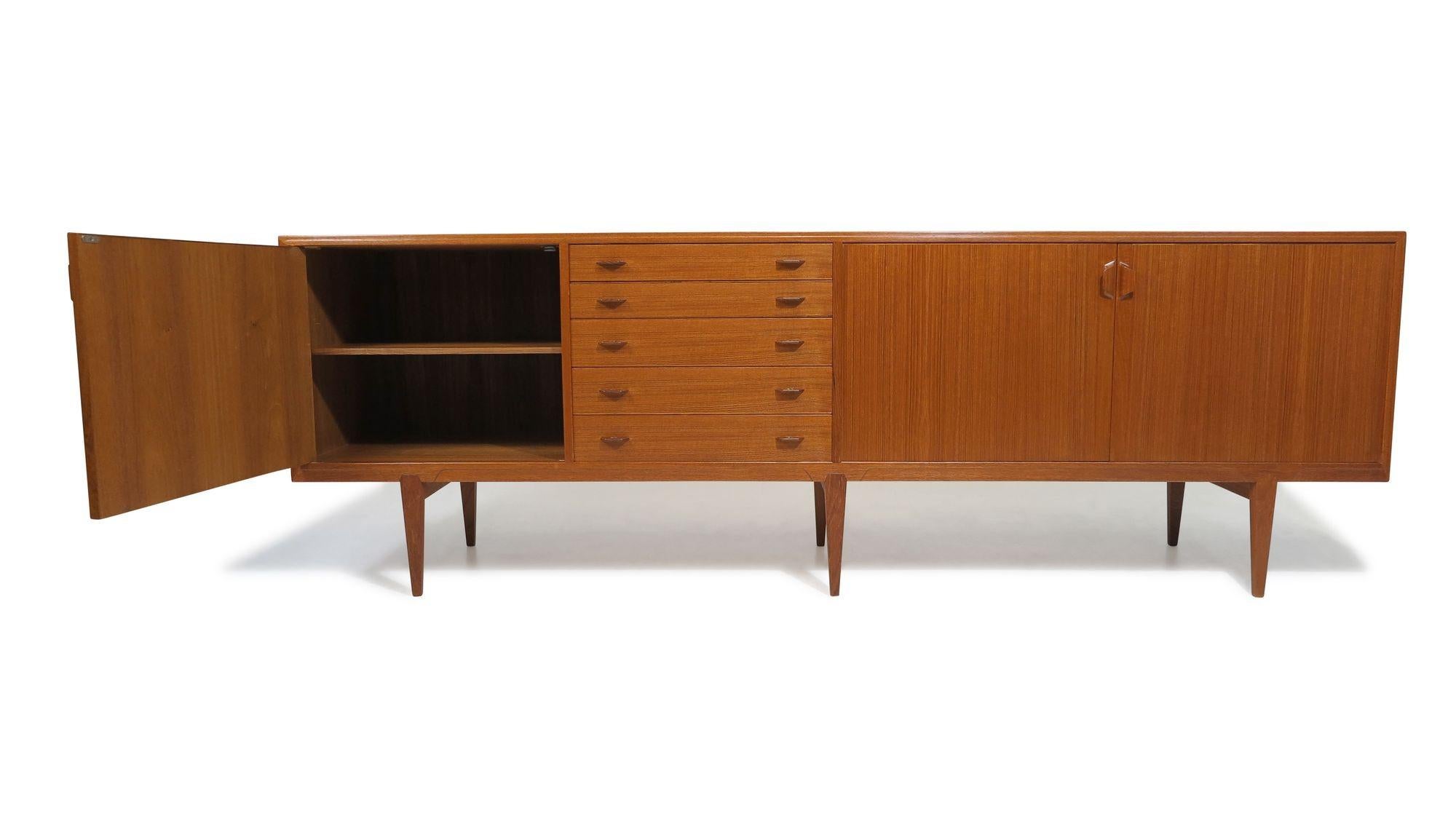 Danish Credenza designed by Henry Rosengren Hansen for Brande Møbelfabrik, Denmark,1955. This impressive 94.5” long credenza is expertly handcrafted from old-growth teak, highlighting the fine joinery characteristic of early Danish furniture design.