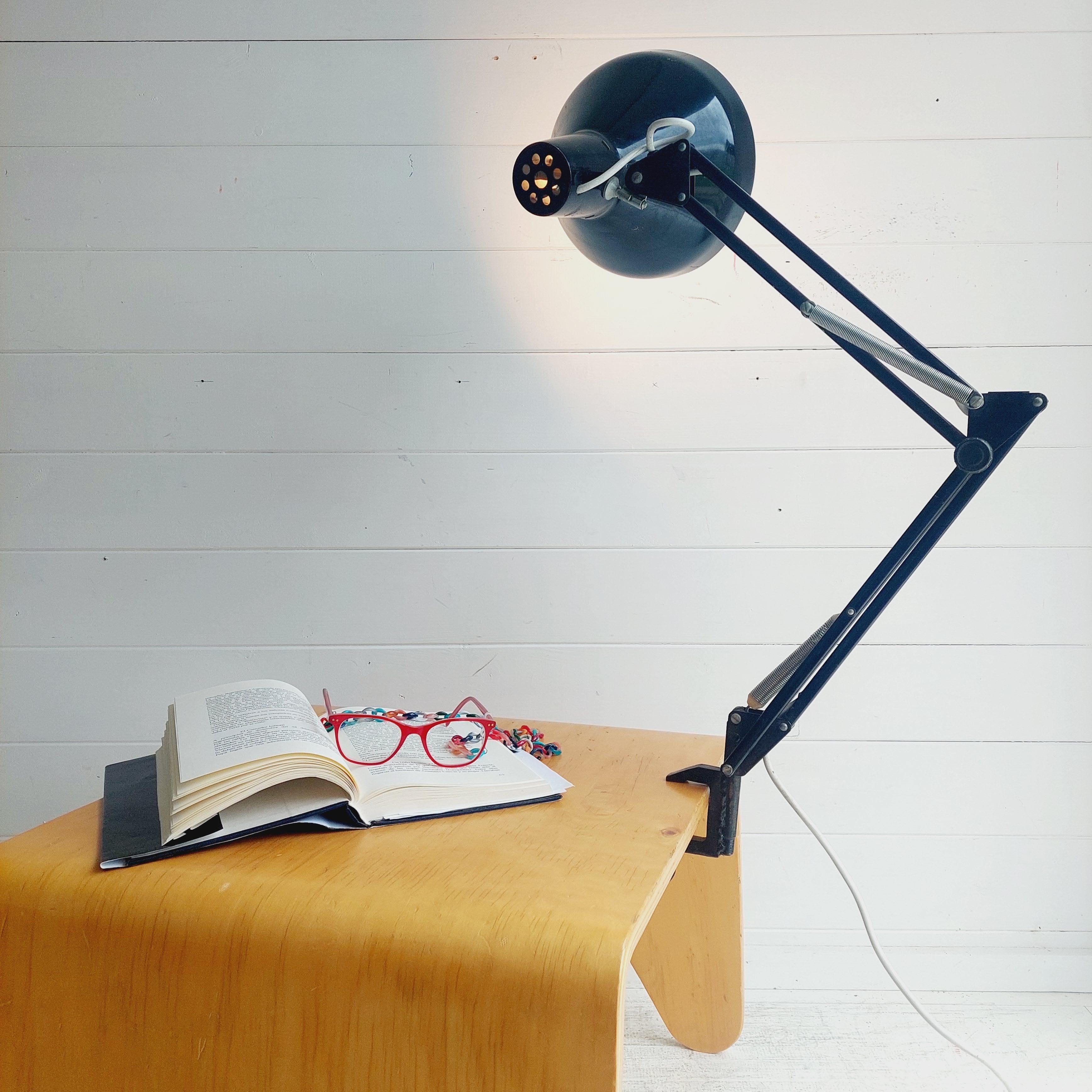 A mid century metal Anglepoise desk light with clamp.
Herbert Terry & Sons Ltd. Black Anglepoise Desk/Wall Clamp Lamp.
Made in the UK and likely 1950s-1960s

We love the industrial feel, especially the simple frame and the reflector shade!
It simply