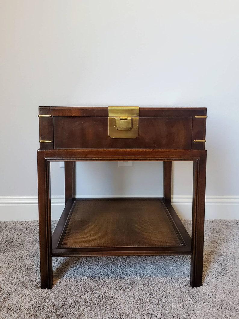 A high quality American mid-century Campaign style burled wooden bedside nightstand cabinet or end table by Drexel Heritage Furniture (North Carolina, United States)

Classic, timeless, traditional American style, that's elegant and sophisticated.