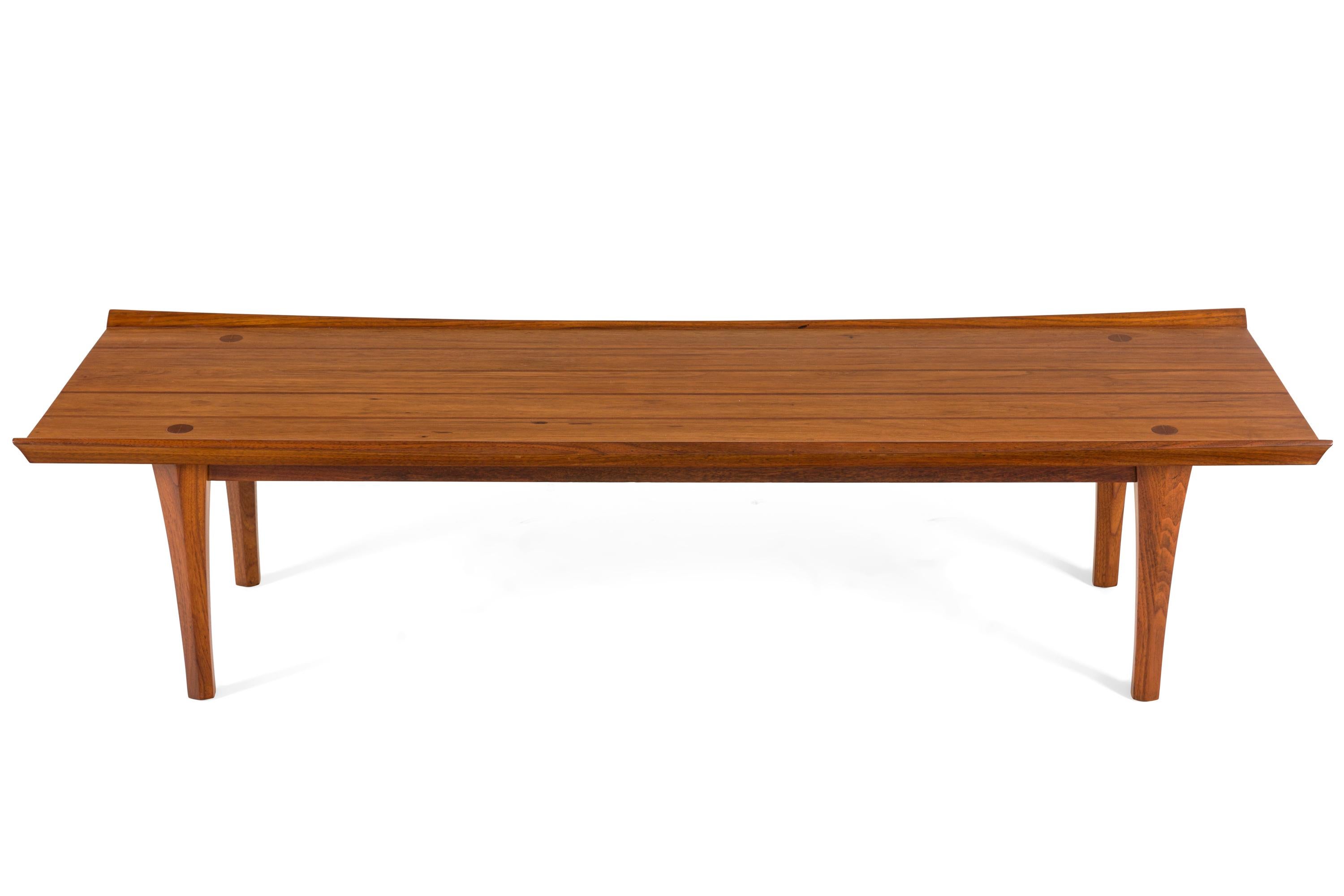 Heritage Henredon furniture made fine furniture in the mid-century style. Frank Lloyd Wright designed for the Heritage furniture line although I can't identify the designer of this table.
