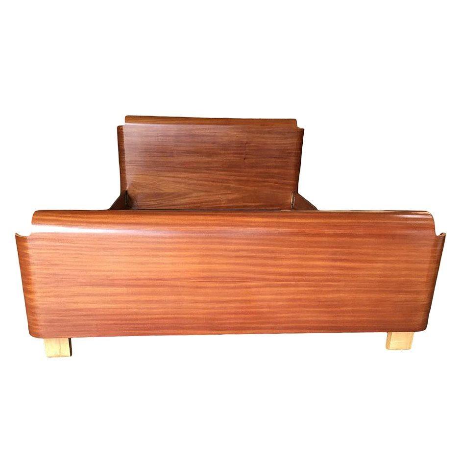 This Mid-Century Modern full-sized bed frame with a dark-stained bent Mahogany plywood head and footboard. The bedframe takes inspiration from the Herman Miller DCW and would be a perfect match with the famous chair.

Headboard: 33