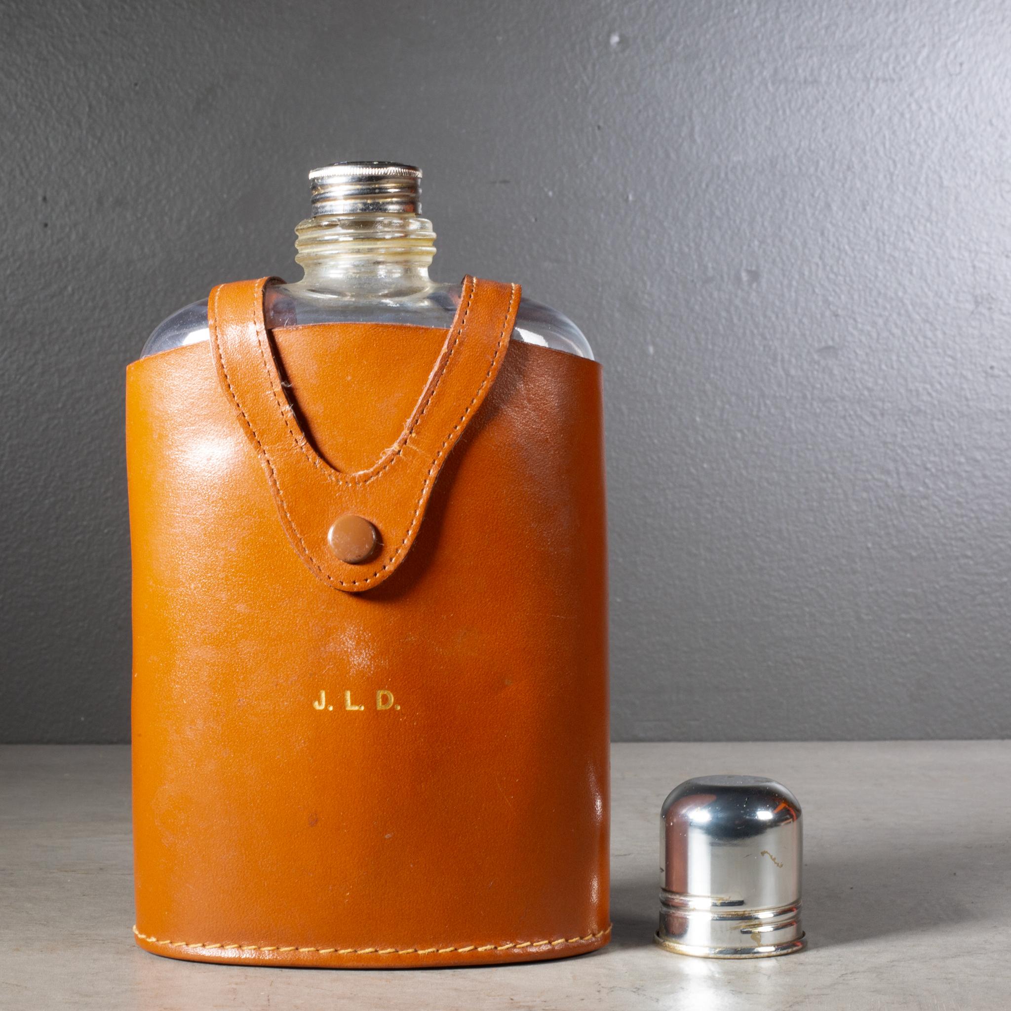ABOUT

A vintage glass hip flask with screw top metal lid and metal shot glass. Leather case monogrammed 