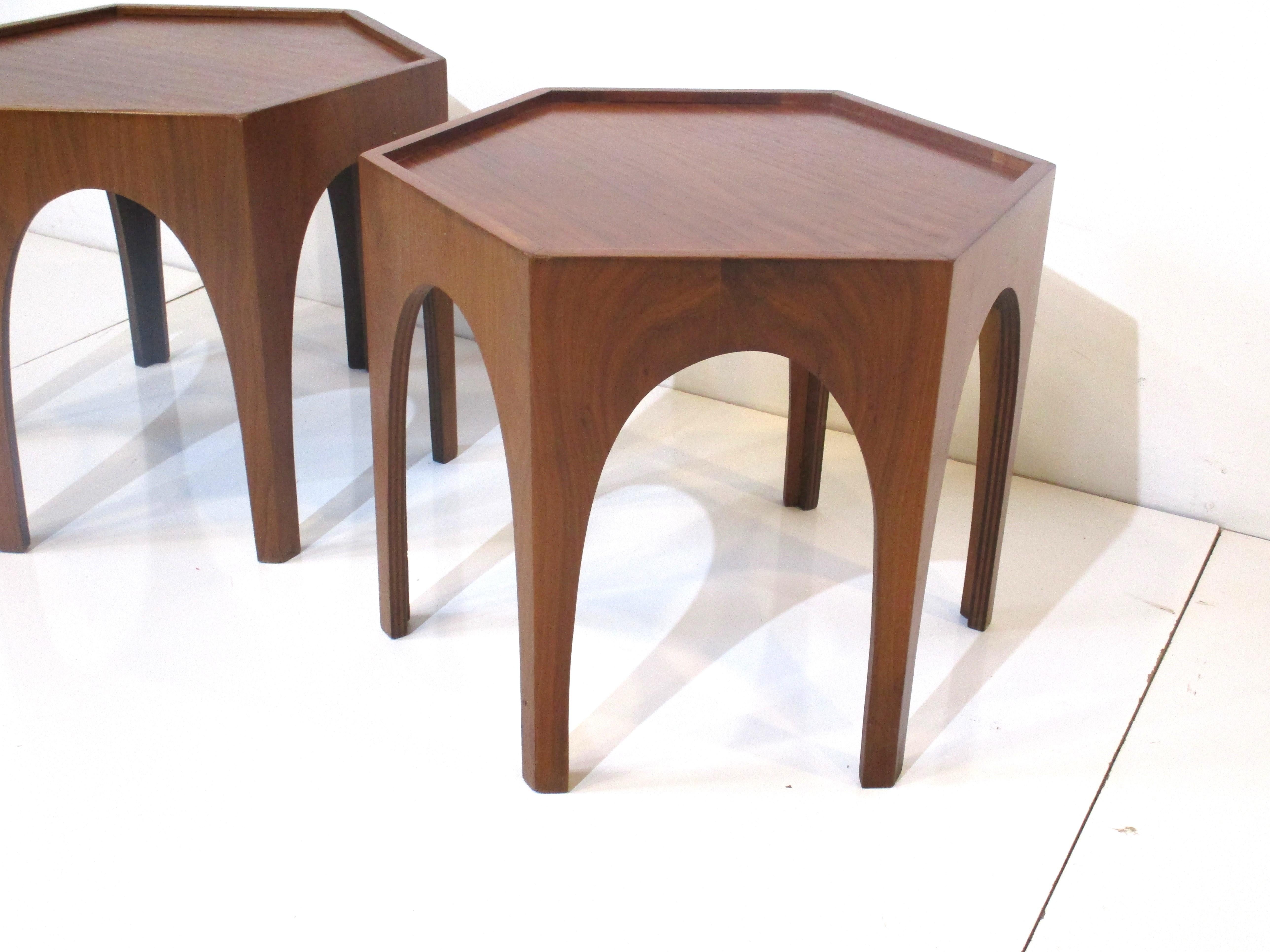 A matching pair of hexagon walnut side tables with tapered legs and slightly raised lip around the edges . Well crafted in the manner of Heritage Furniture company with great graining and color.