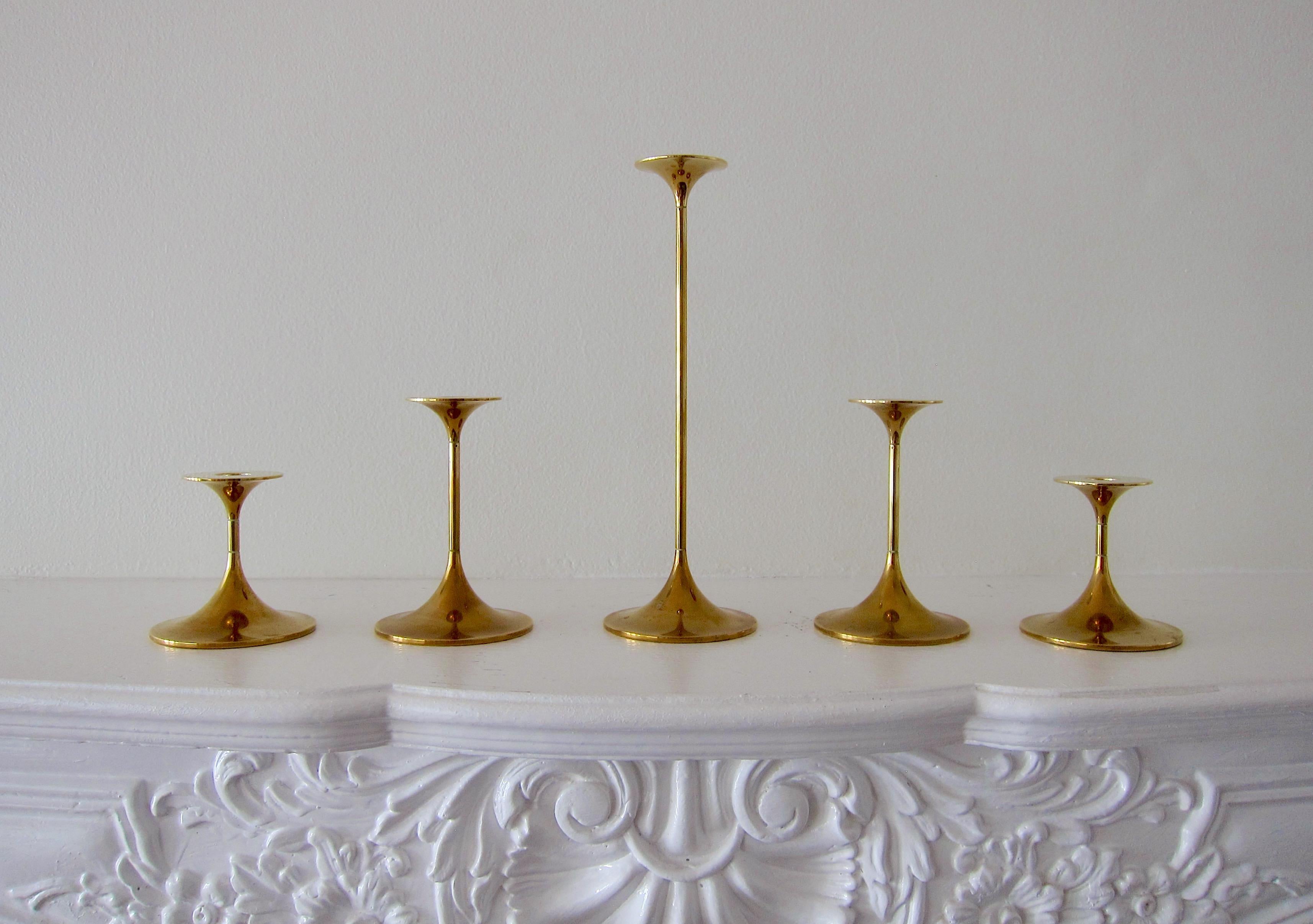 A set of five Scandinavian modern hi-fi candlesticks in solid golden brass designed by architect Max Brüel (1927-1995) for Torben Ørskov of Copenhagen, Denmark in 1960. These sleek, minimalist candle holders of graduating size are in very good