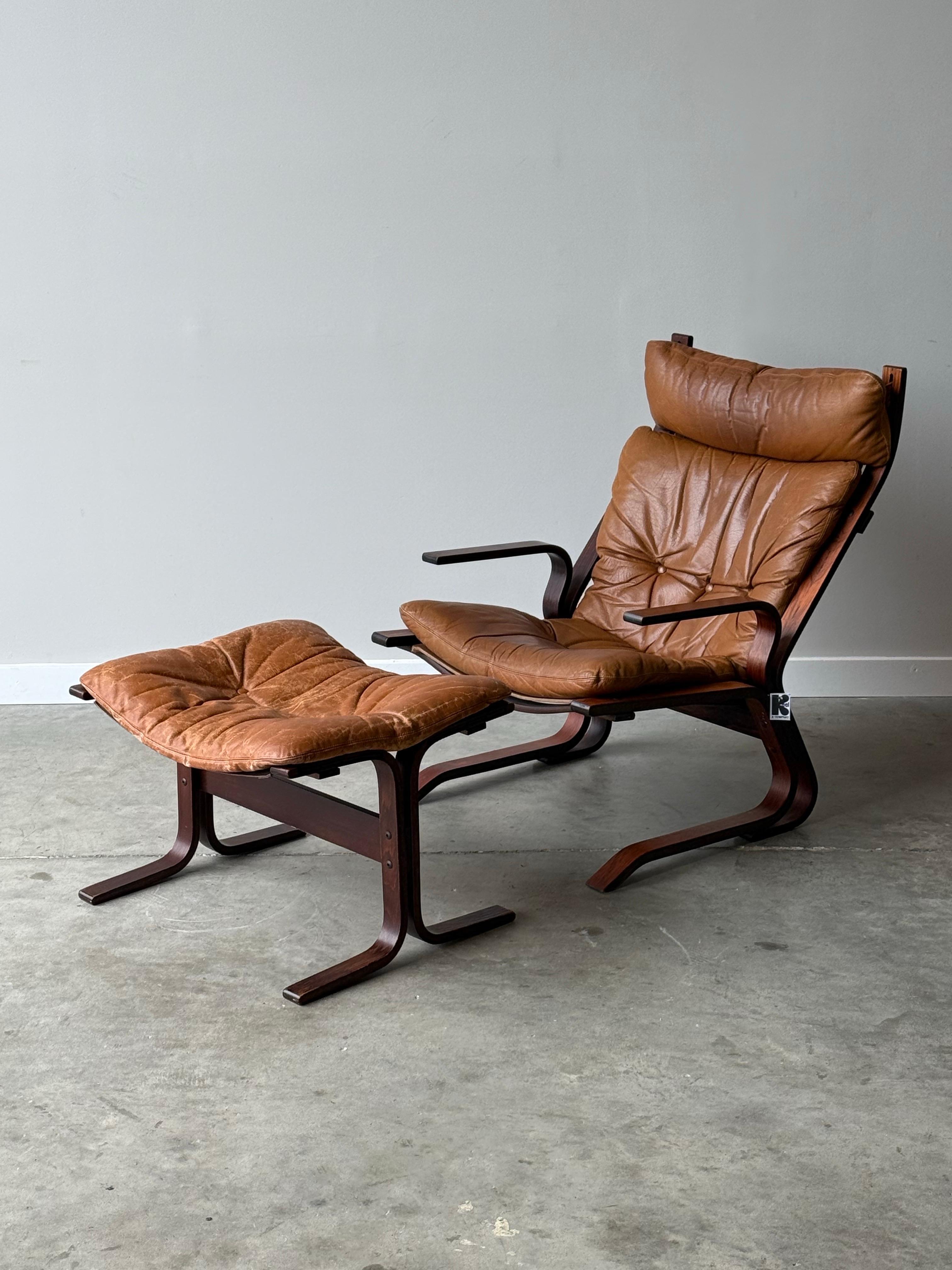 Mid-Century high back armchair and ottoman designed by Oddvin Rykken for Rybo and Co. Made in Norway circa 1960s. The sleek wooden frame made from beech wood is an absolute show stopper. Showcasing stunning bentwood curved armrests and legs that