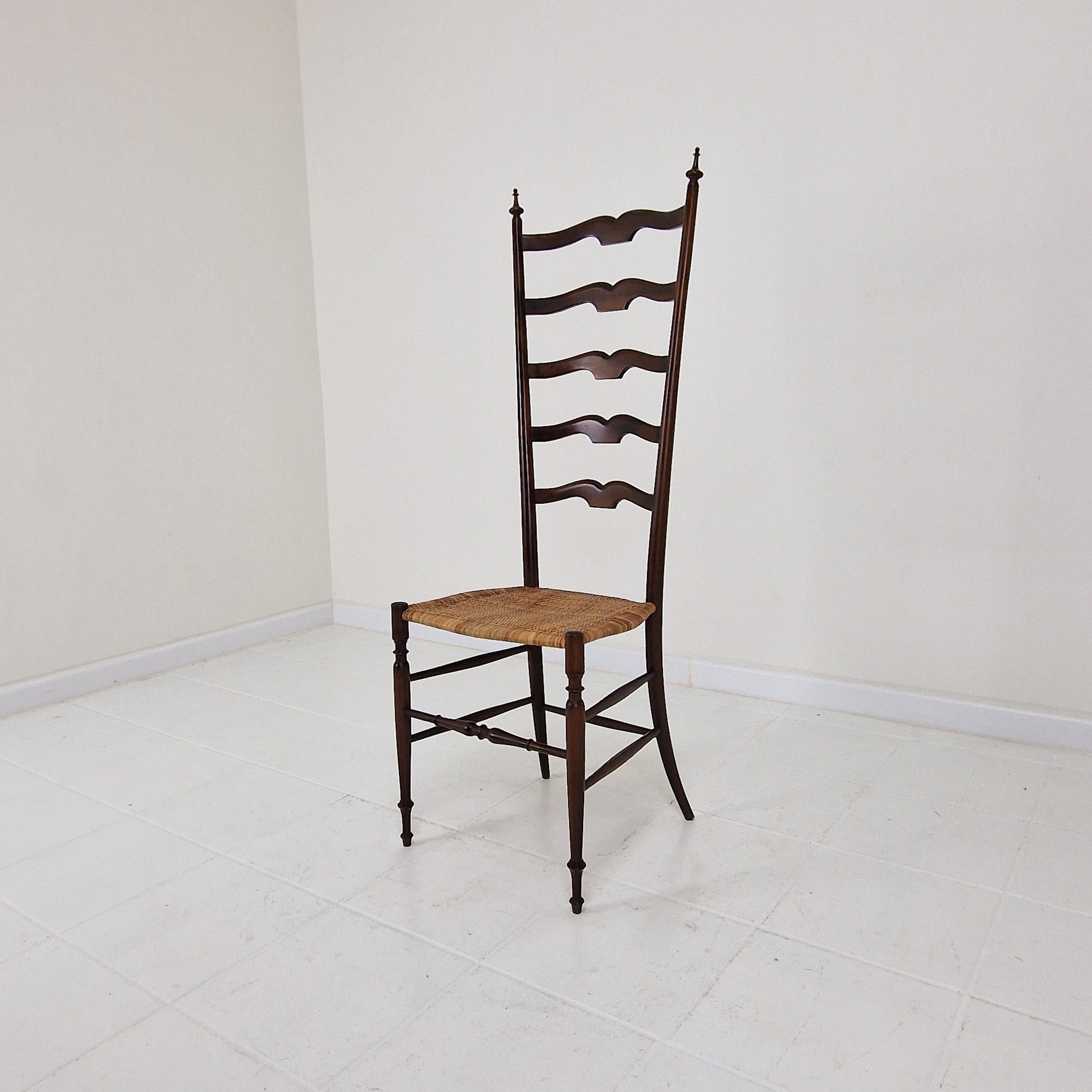 A beautiful ladder high-back chair by Chiavari fabricated in Italy, 1950's.

Slim design and amazingly light and firm.
Ebonized hardwood frame with cane seat.

The seat and the structure of the chair is in good condition, some traces of use (see the