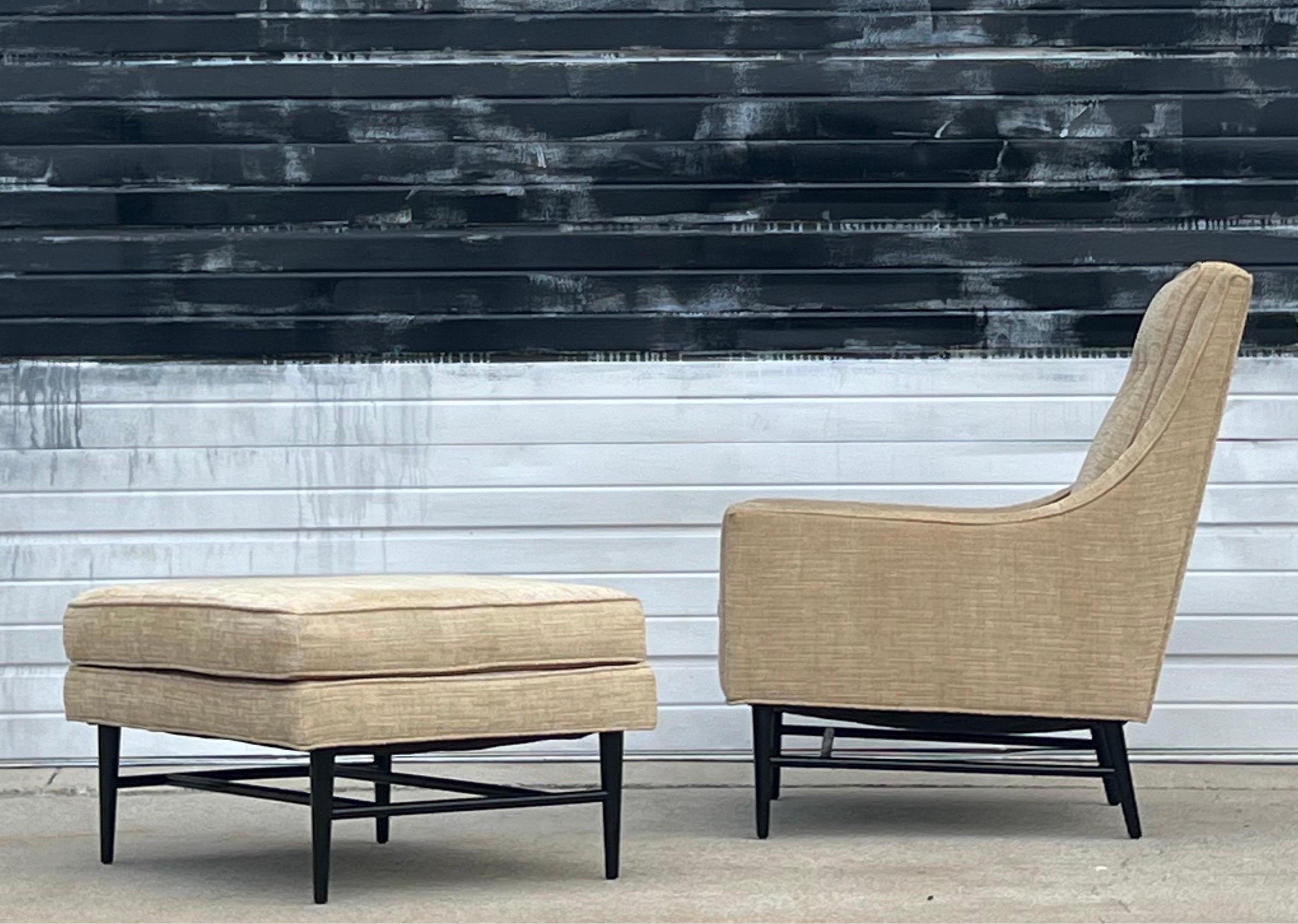 Elegant high-back lounge with matching ottoman. This chair is extremely comfortable supporting both the neck and back. In the style of Milo Baughman and Paul McCobb. Black lacquered wooden base with tapered legs. The base of the lounge and ottoman