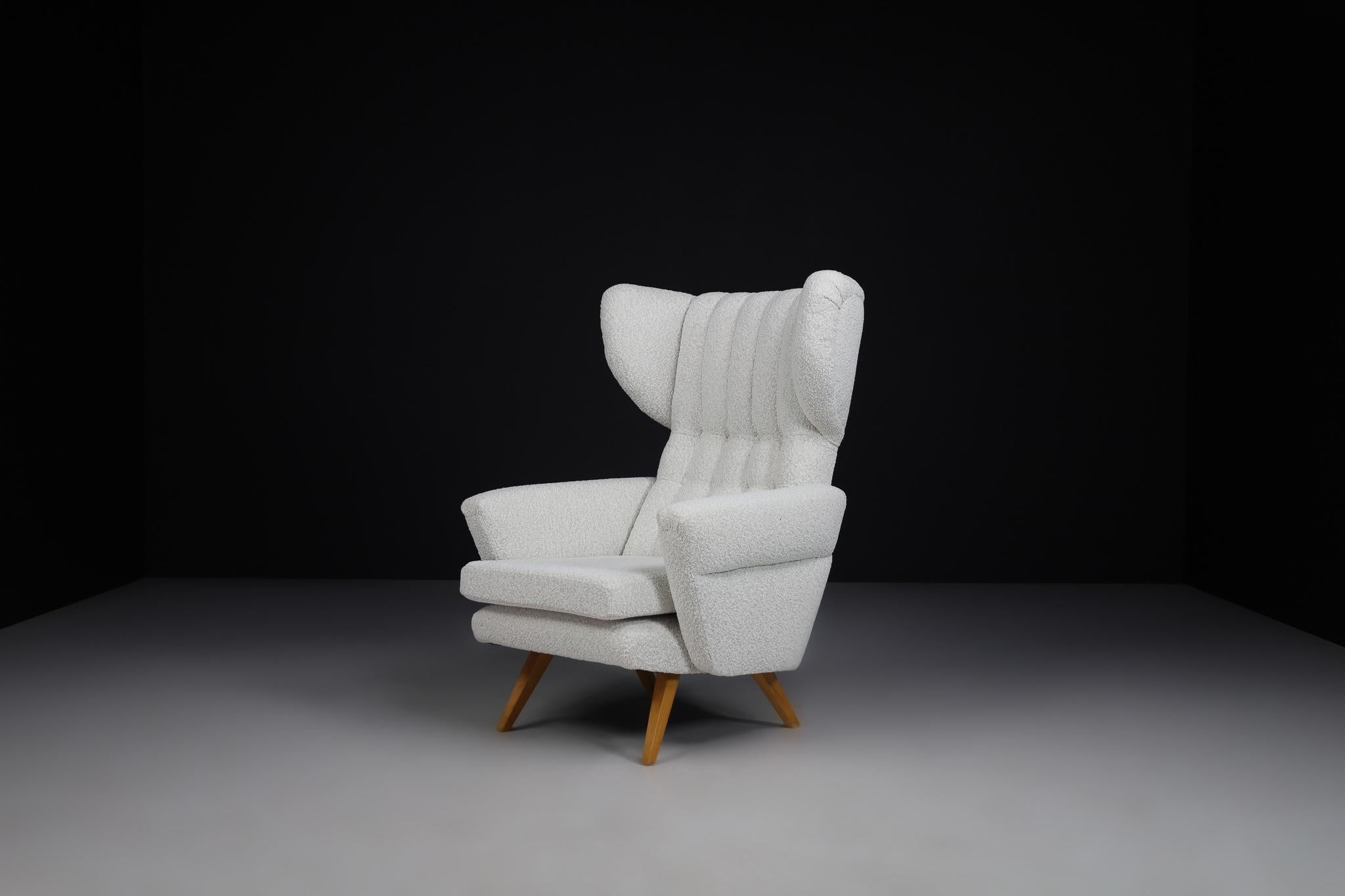 Mid Century High Back Lounge chair in Reupholstered Bouclé Fabric, Praque 1950s

Large midcentury wingback armchair in re-upholstered bouclé fabric, Czech republic 1950s. This armchair would be an eye-catching addition to any interior, such as a