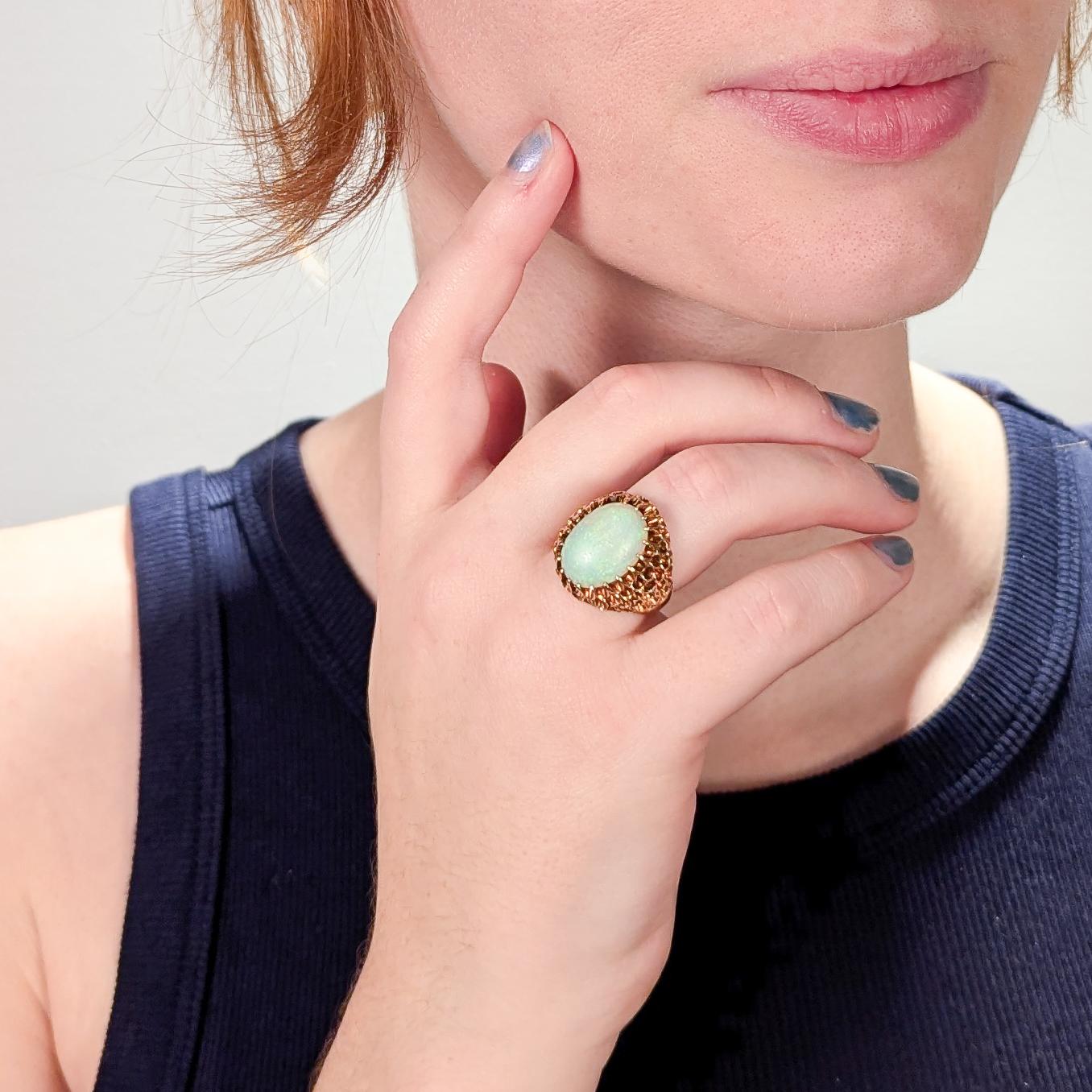 A fine gold & opal cocktail ring.

In 14 karat gold.

With an opal cabochon high-set in a beehive setting.

Hallmarked faintly to the interior shank.

With an old resizing marks to the shank. 

Simply a wonderful Mid-Century opal