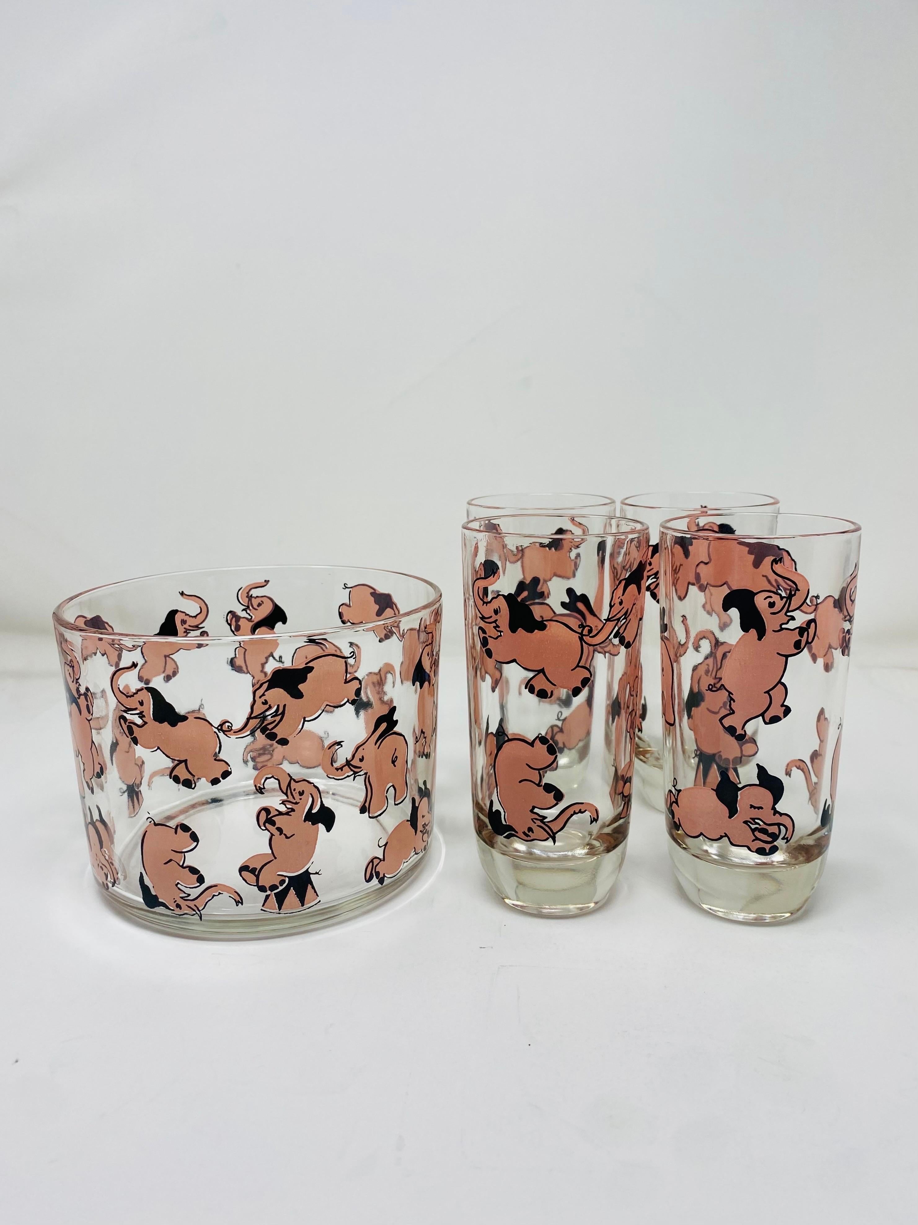 Beautiful set of 4 glasses and ice bucket from Hazel Atlas.  This pieces are from the Mid-Century era of Atlas commanding design in barware.  This set is from the rare and sought after Dancing Pink Elephant collection.  The simple lines are