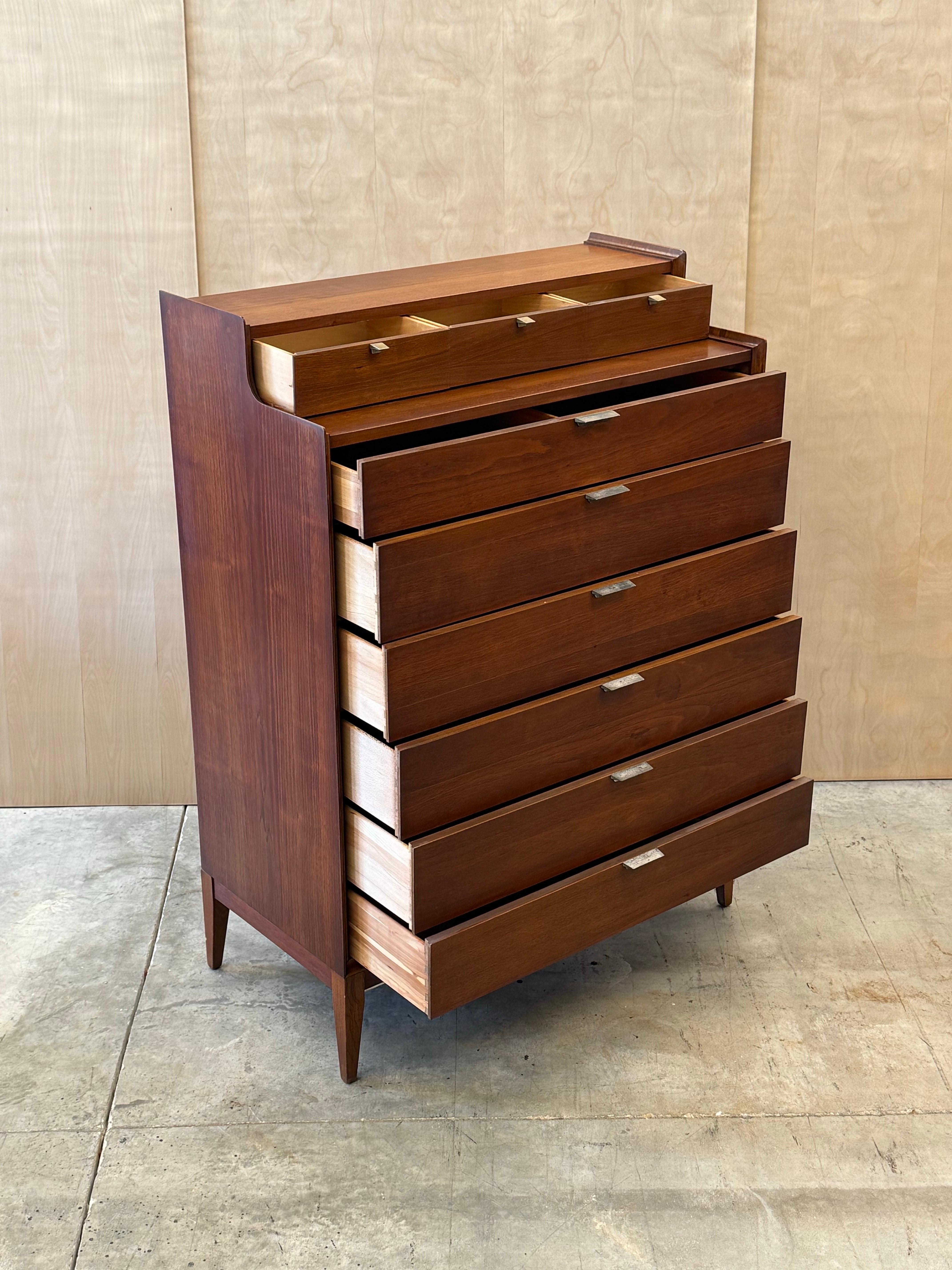 Mid-century highboy dresser designed by Arthur Umanoff for Cavalier Dimension Group, circa 1960s. A distinctive highboy dresser made from warm walnut wood with ample storage potential, without comprising a large footprint.

This piece has a large