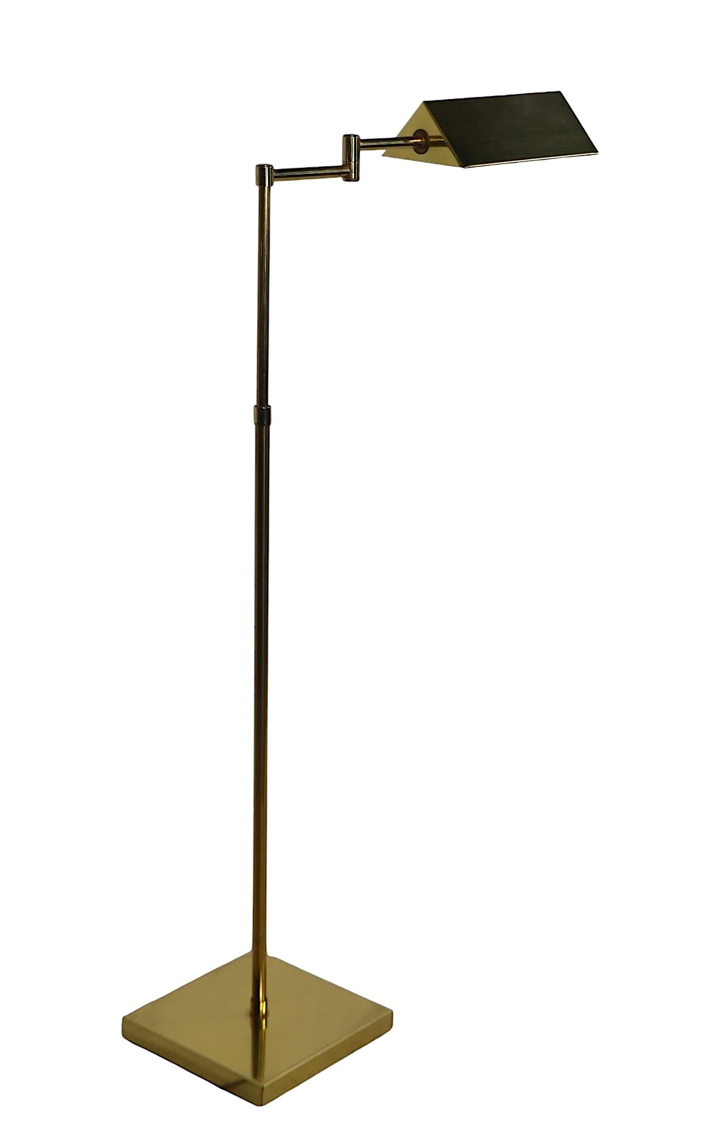 Nice clean, working vintage brass pharmacy style floor lamp, probably by Alsy, in the style of Koch & Lowy, unsigned. The lamp features a tent form brass hood shade which rotates to direct the light, two flex arms and an adjustable vertical standard