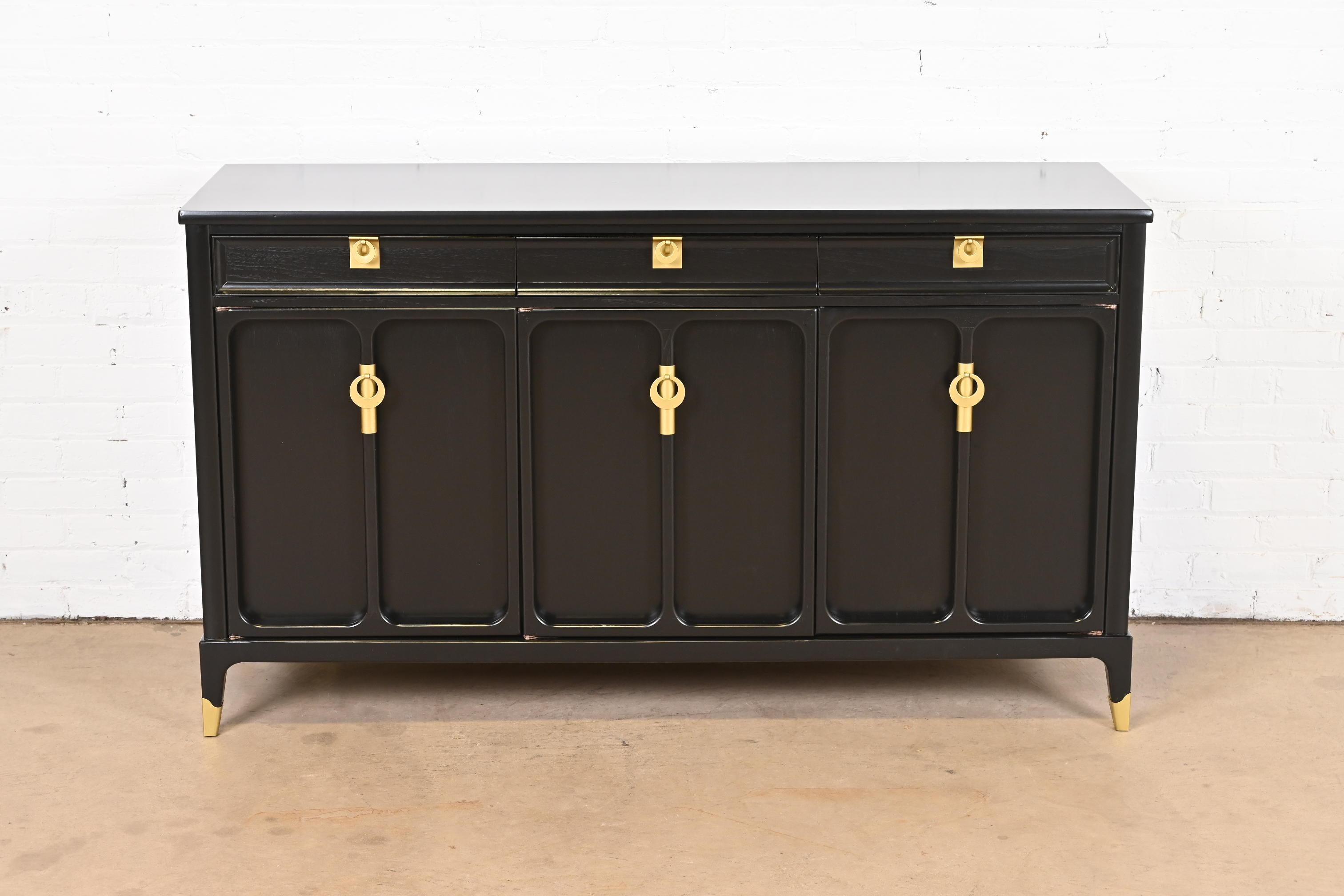 An exceptional Mid-Century Modern Hollywood Regency sideboard, credenza, or bar cabinet

By White Furniture

USA, 1960s

Black lacquered walnut, with original brass hardware.

Measures: 58