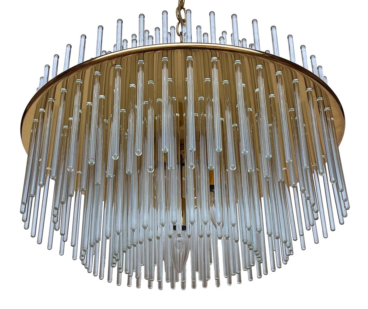 A simple elegant looking hanging light circa 1970's. It features a brass main structure with thin glass rods. It takes 5 light bulbs and is tested and working.