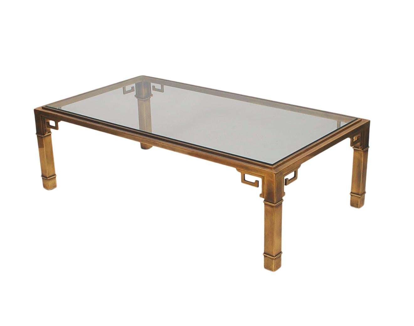 Mid-Century Modern classic with and Asian flair. This large rectangular coffee table features a brass frame with clear inlayed glass.