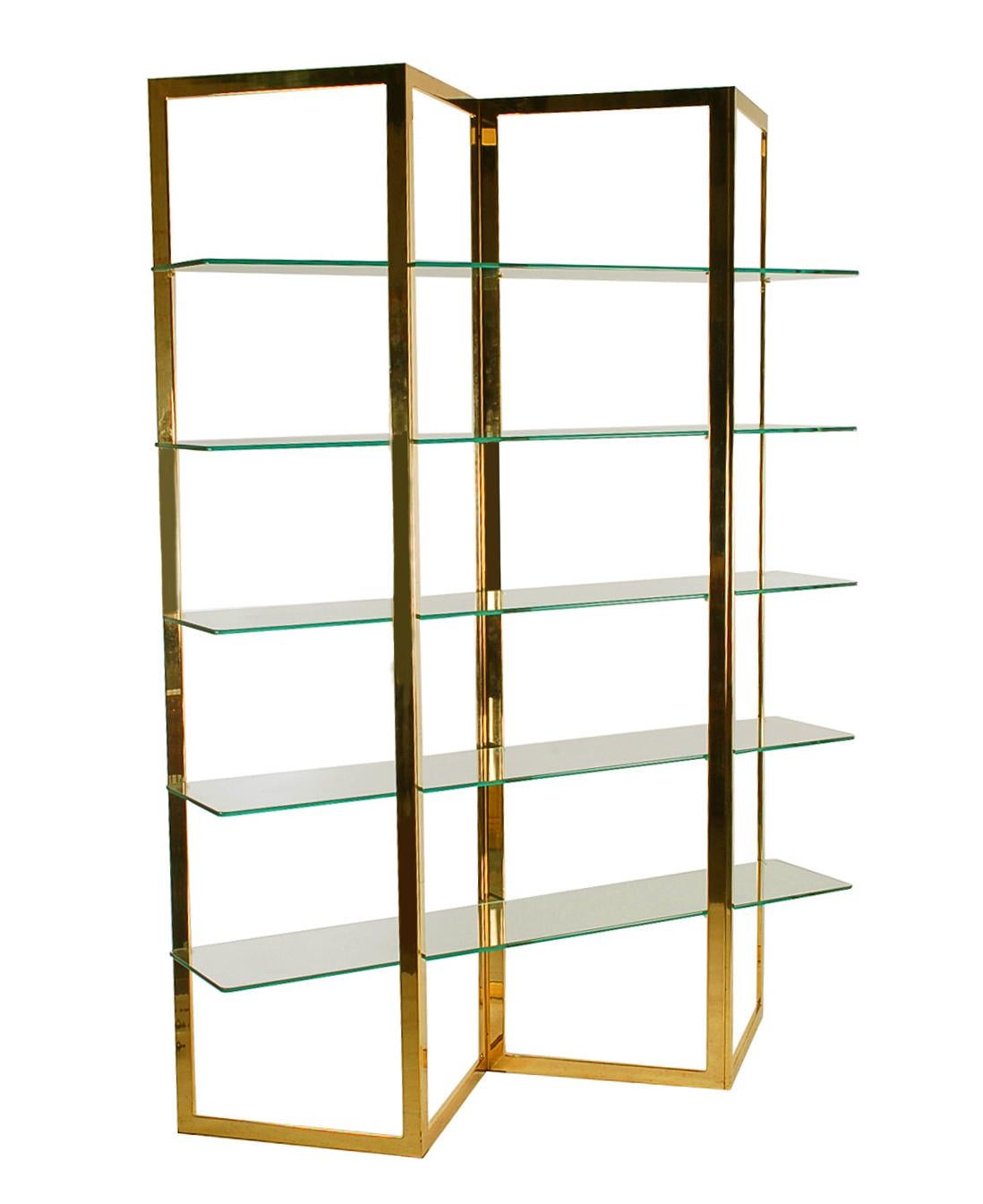 A beautifully designed etagere from the late 1970's. It features brass flat bar framing in a fan form with heavy clear glass shelving.