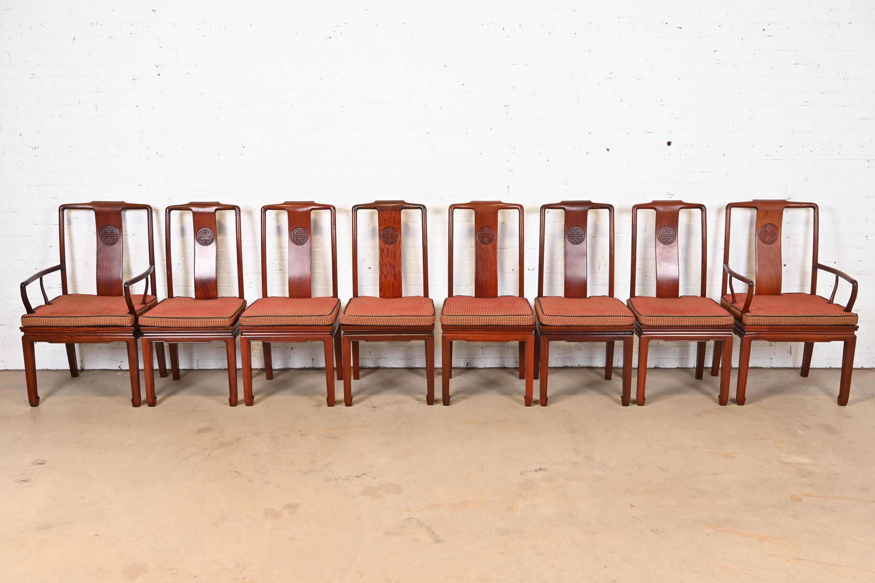 A gorgeous set of eight mid-century modern Hollywood Regency Chinoiserie dining chairs

In the manner of Henredon

USA, Mid-20th Century

Solid carved rosewood frames, with removable upholstered seat cushions.

Measures:
Side chairs - 18