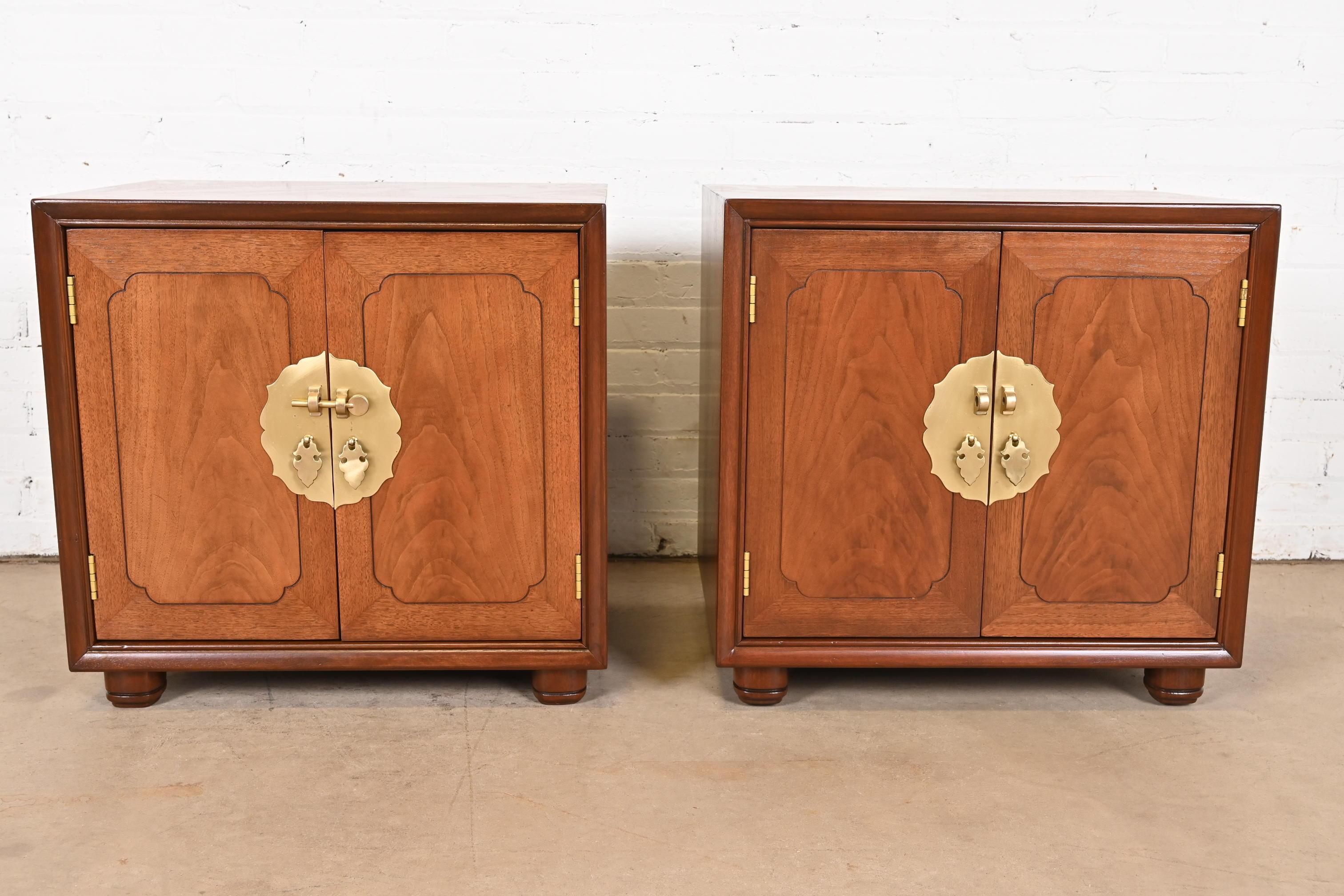 A gorgeous pair of mid-century modern Hollywood Regency Chinoiserie nightstands or bedside chests

Attributed to Henredon

USA, Circa 1970s

Carved walnut, with original Asian-inspired brass hardware.

Measures: 24