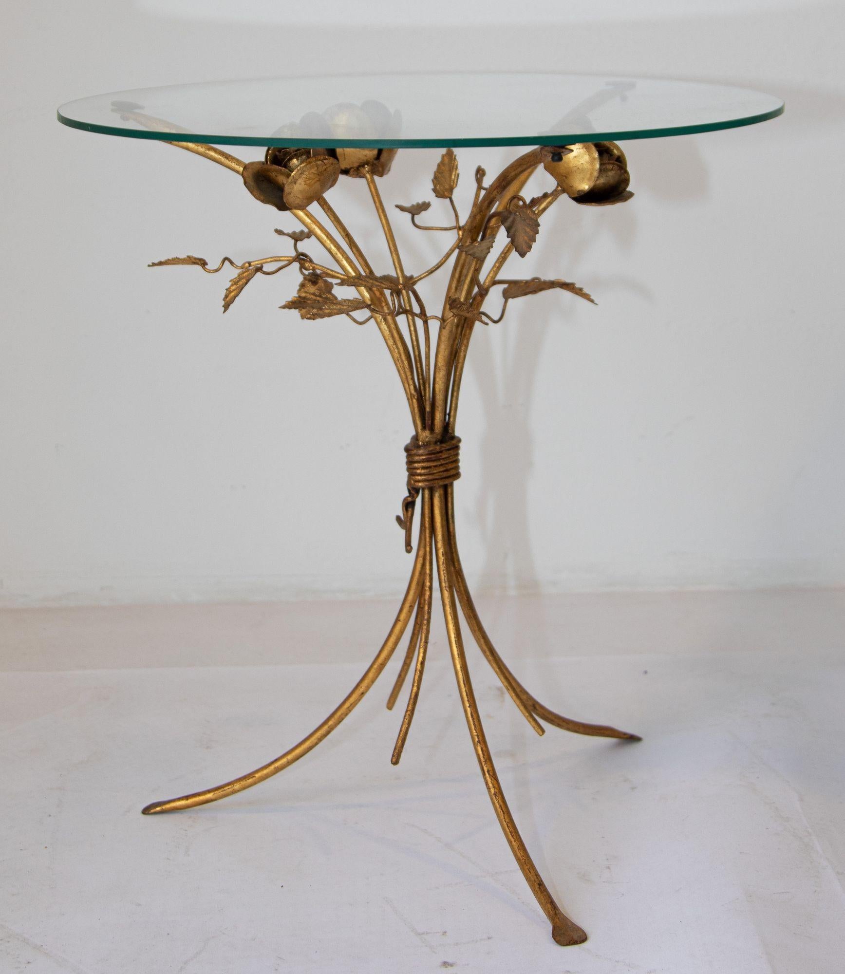 Mid-century Hollywood Regency gilt metal leaf and flower side table by Hans Kögl.
Flower side table on a tripod base with flower details by Hans Kögl.
Mid-century side table with a round glass top seating on a gilt metal tripod base.
Hollywood