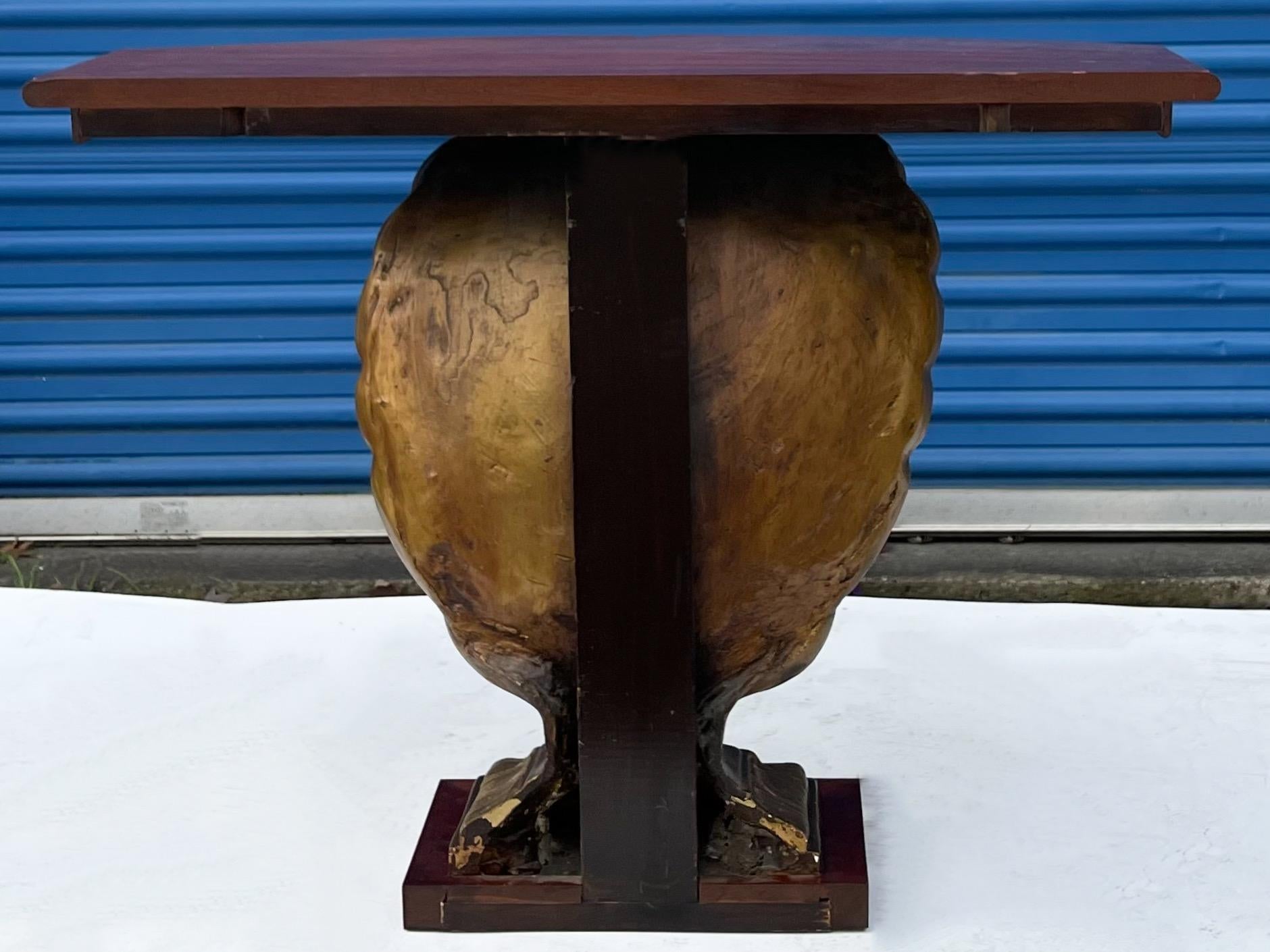 This is a mid-century Hollywood Regency Era gilt shell and mahogany console table. It is most likely a Grosfeld House piece. The shell appears to be some sort of cast decorative material. It is in very good condition.