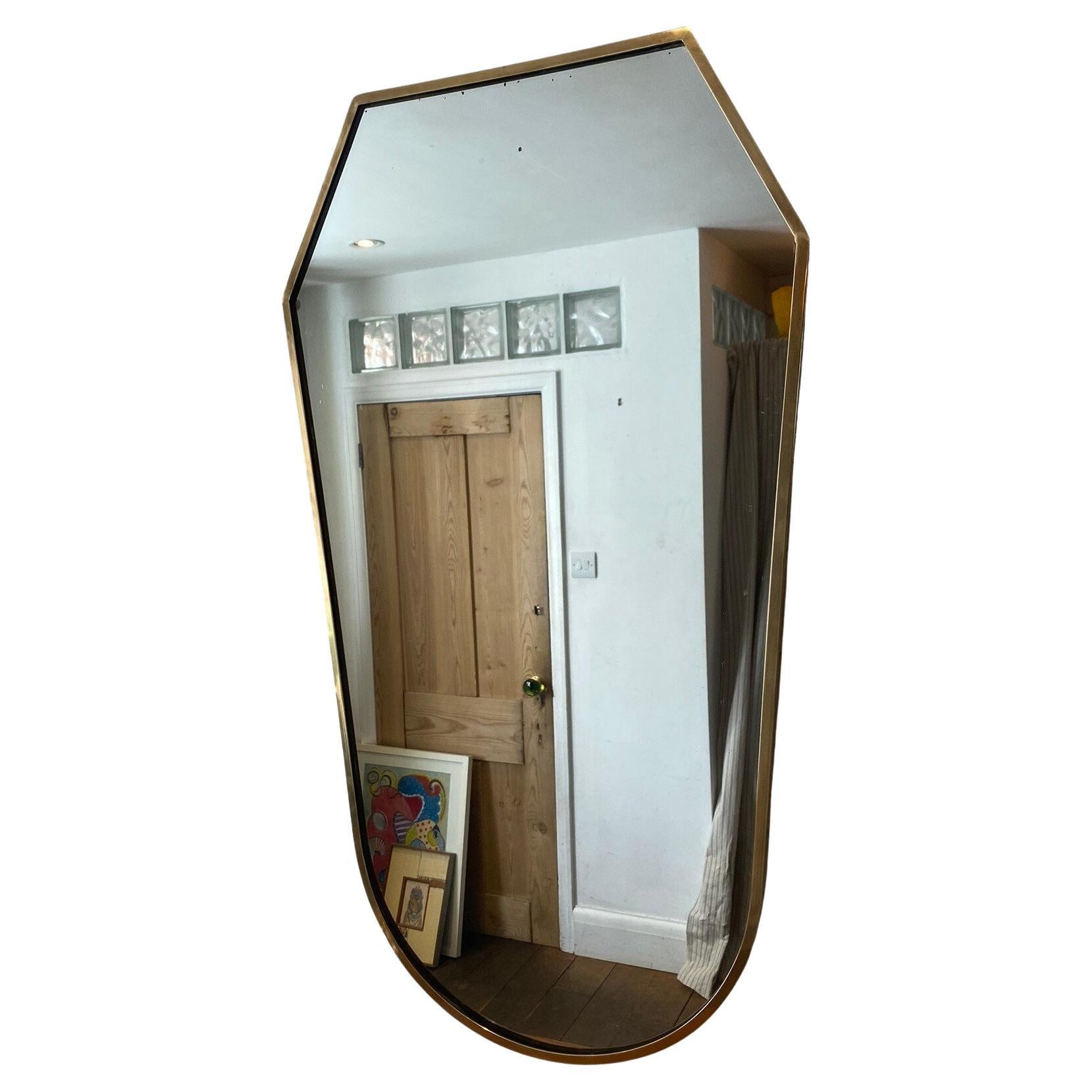 Mid-Century Hollywood Regency Italian Brass Framed Mirror, 1950s

A stunning mid-century brass framed 'shield' shaped mirror in the style of Gio Ponti. Wooden back.            

Italian, 1950s

Condition:  Light wear consistent with age and use (a