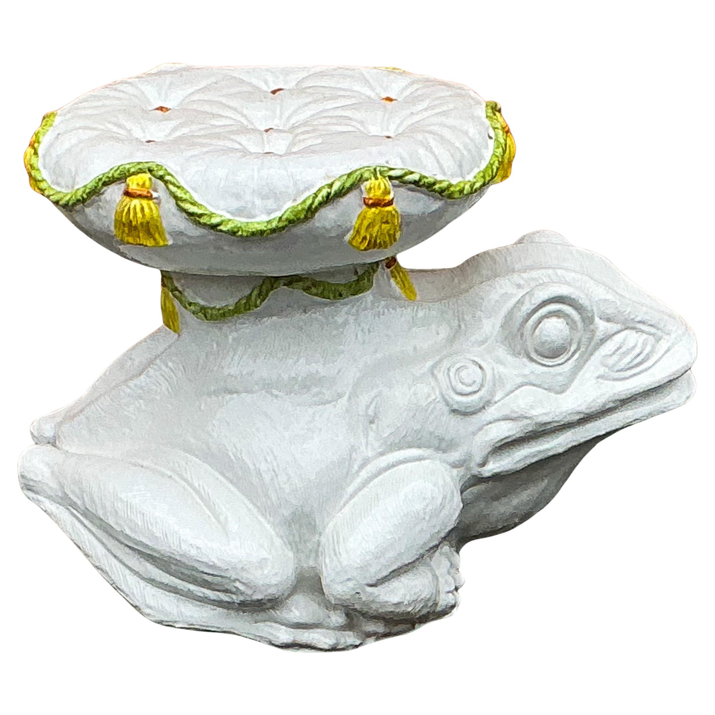 This is a wonderful Italian Hollywood Regency Era white glazed toad / frog garden stool with tufted cushion seat. The seat has yellow tassels and buttons. It dates to the 60s and is unmarked. It is in very good condition.