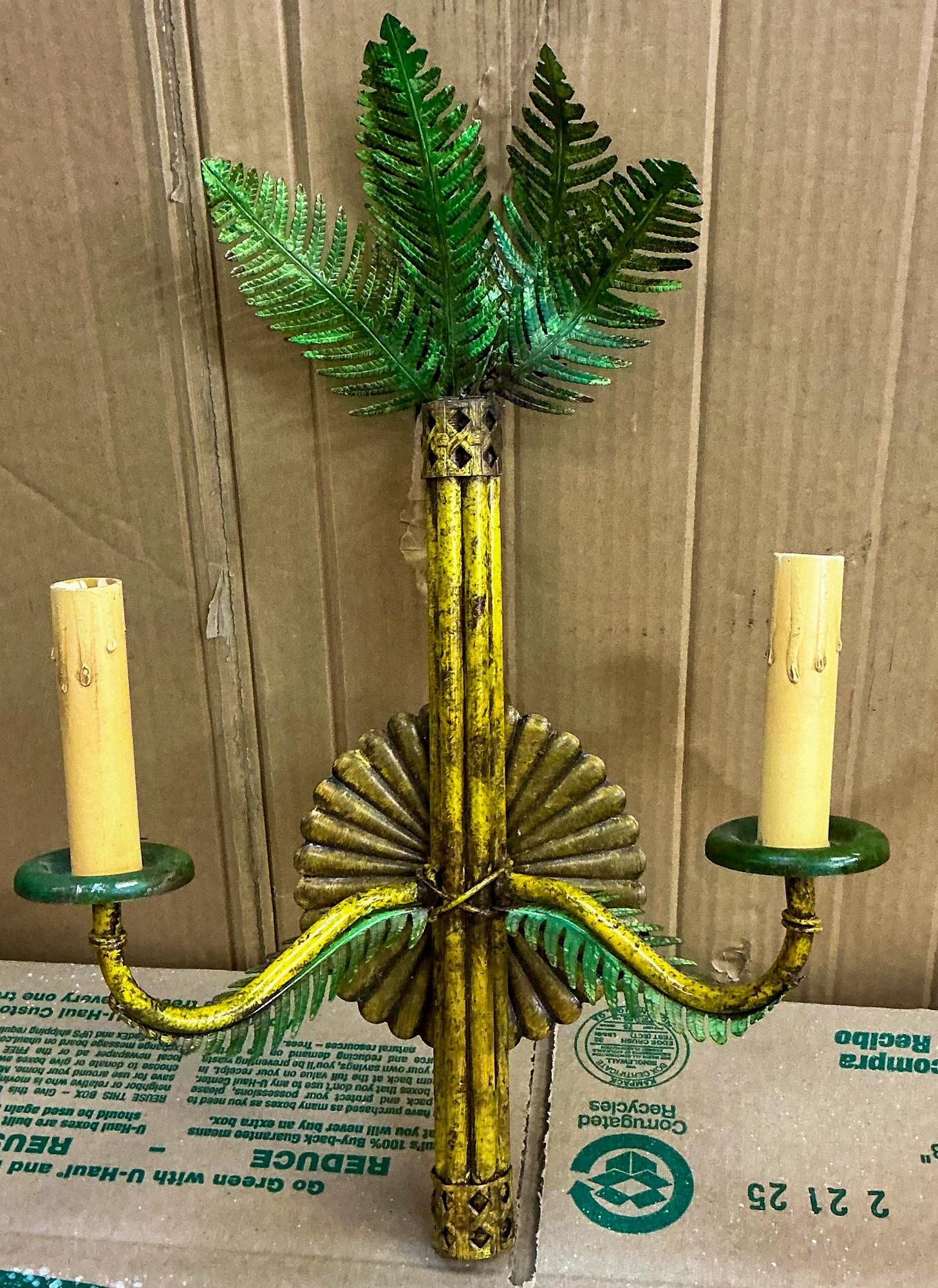 This is a pair of Italian palm tree form tole sconces. They are hand painted in vibrant greens and distressed yellows. They are in working order and unmarked. 