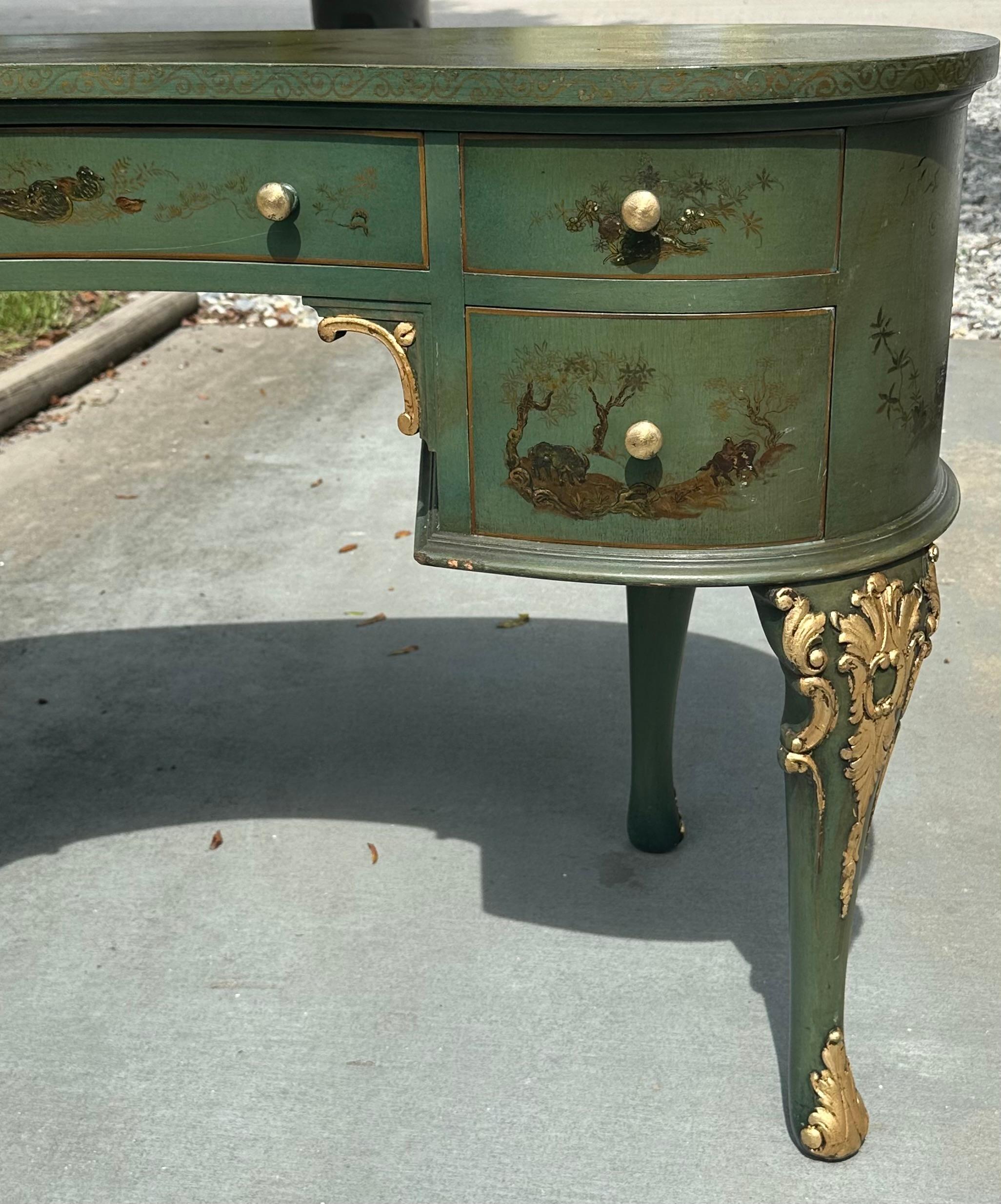 Mid-Century Hollywood Regency Kidney Shaped Writing Desk

Elegant mid-century Hollywood Regency kidney shaped writing desk with gilt accents. The olive-green painted desk is decorated on all sides and top with Japanese motifs. It is built with five