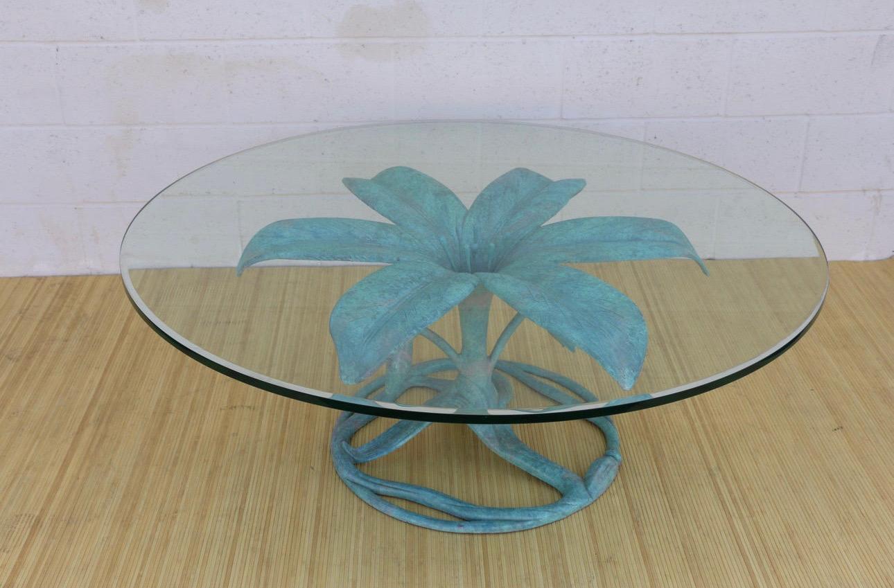 Amazing vintage Hollywood Regency turquoise lacquered coffee table designed by Arthur Court in the style of a lily flower, it has no label or stamp of designer. This coffee table is made of aluminum and it has a round glass top. In good used vintage