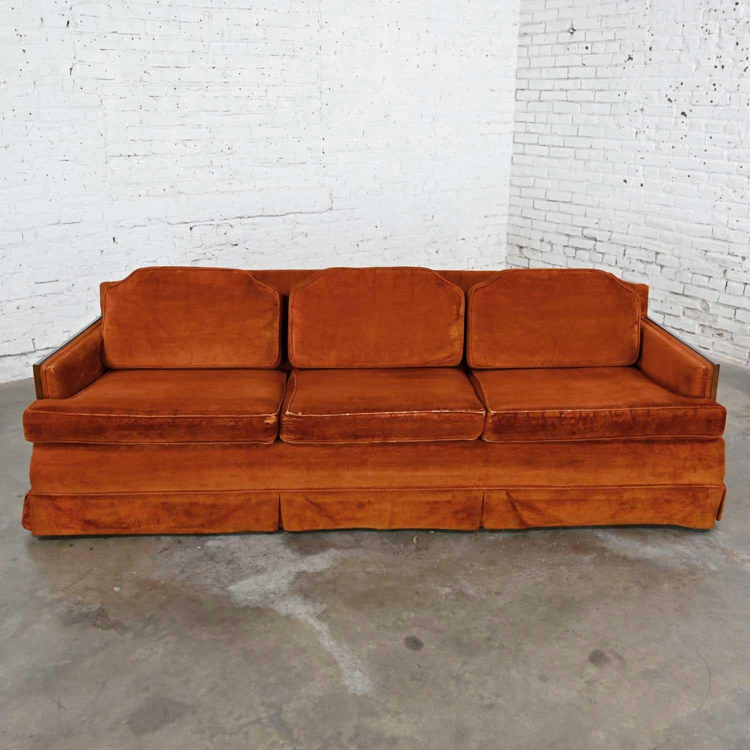 Outstanding mid-century Hollywood Regency rust colored brushed chenille Lawson style sofa with walnut trim and tapered square legs. Beautiful condition, keeping in mind that this is vintage and not new so will have signs of use and wear. The wood