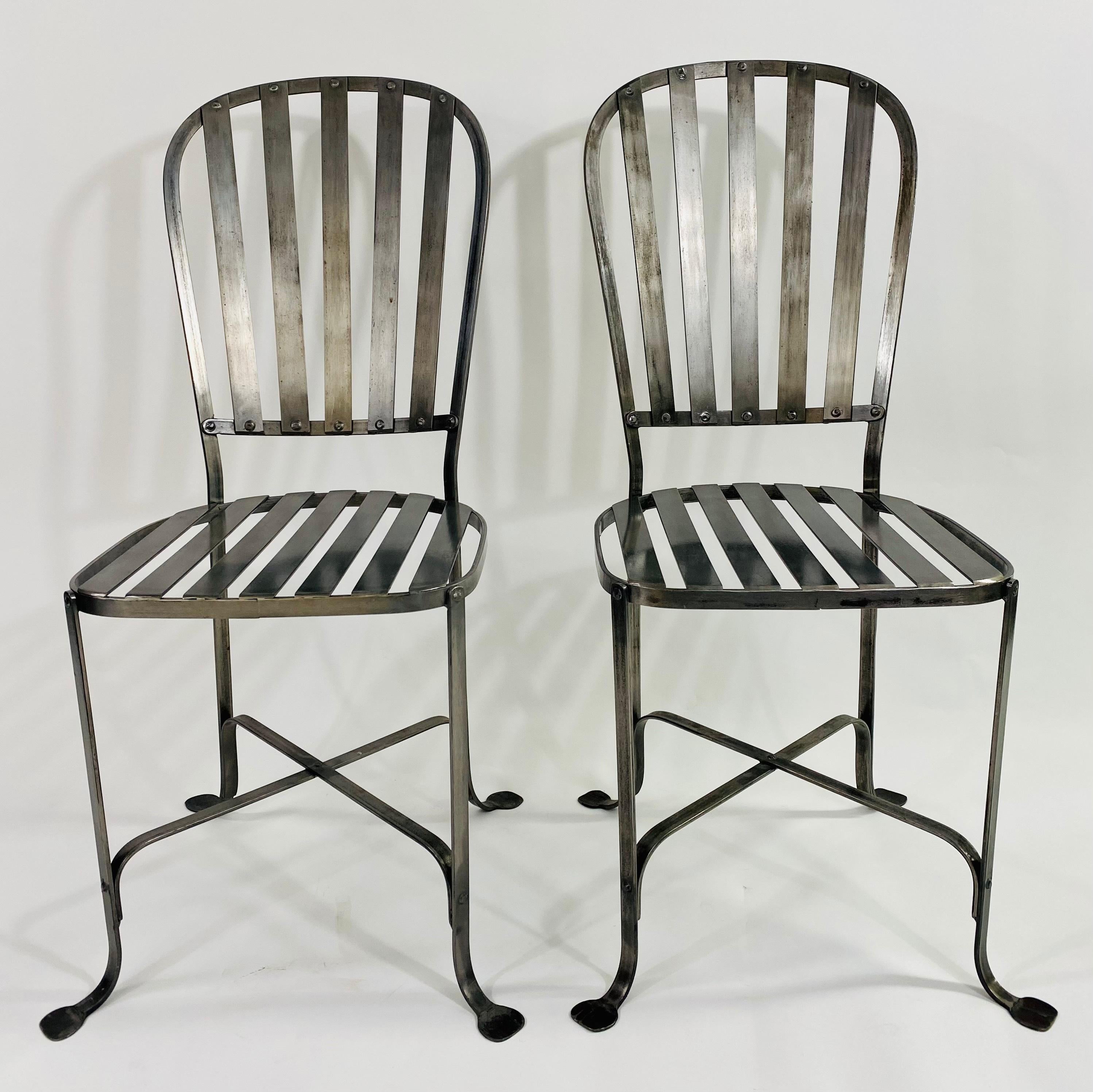 A quality set of 4 mid-century Hollywood Regency style chairs. Finely crafted of metal in pewter finish, the chairs are sturdy and can be used for indoor as well as outdoor. Beautifully designed, the chairs feature an X shaped support and elegant