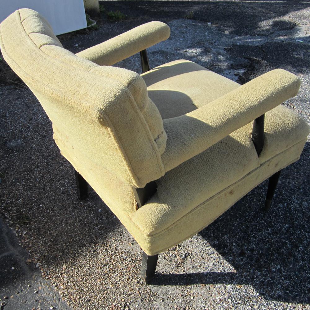 Lounge chair with tufted cushion backing and plump seating. The legs, arms, and backing supports are all finished in black lacquer.  Reupholstery needed.