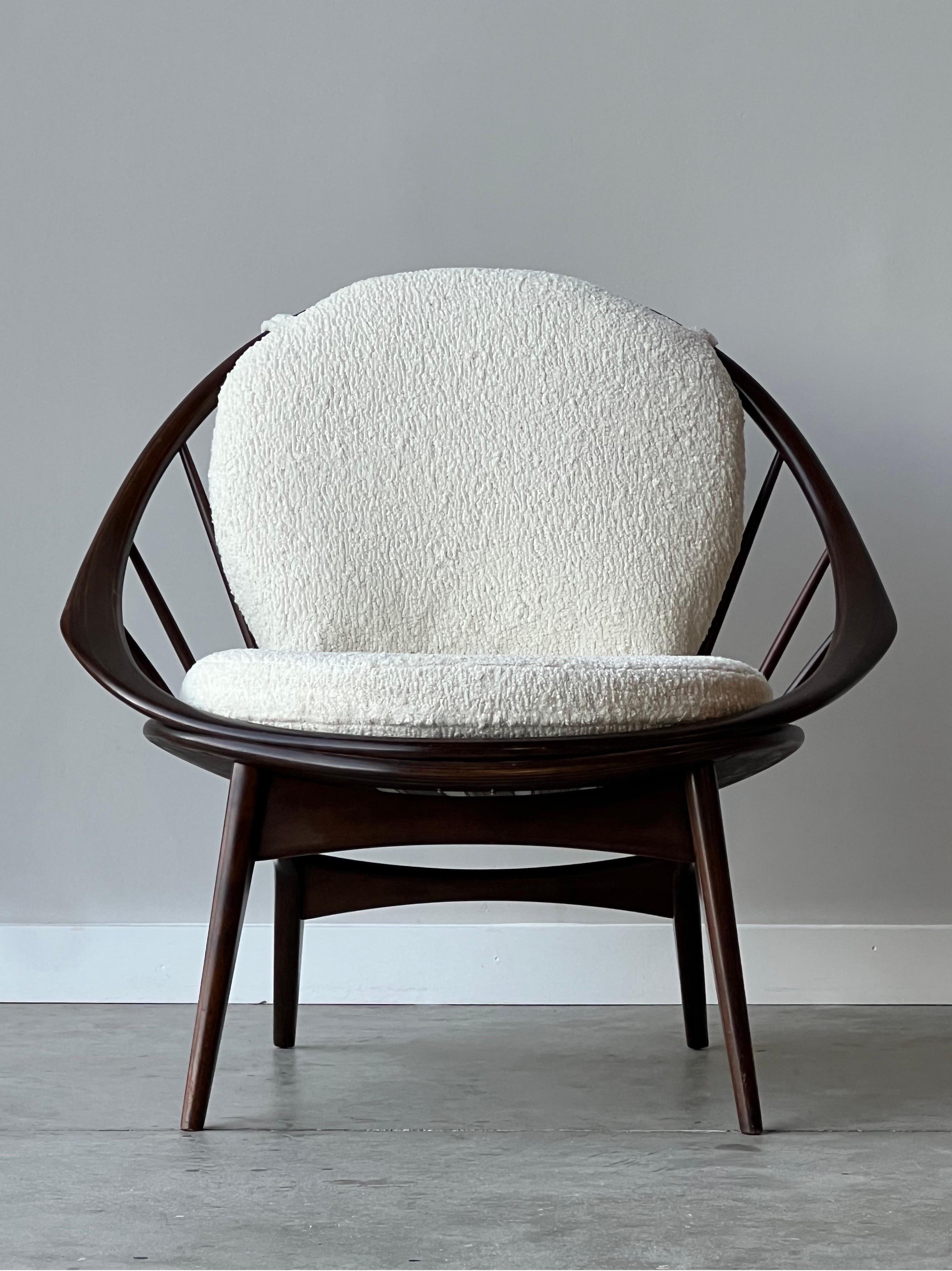 Mid-century chair designed by Ib Kofod Larsen for Selig, Denmark. Rightfully named the ‘Hoop’ chair for its unique circular frame and spindle back. Legs are flared creating a comfortable seated position and wonderful side profile. Newly