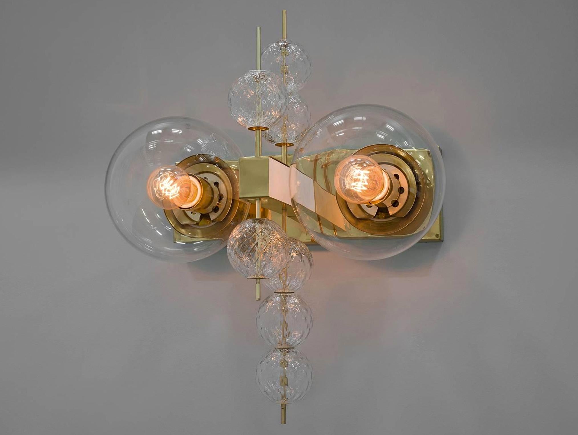 Large set hotel wall chandeliers with brass fixture and large handblown glass. The scones are beautifully decorated thanks to the structured glass. The pleasant light it spreads is very atmospheric, these wall chandeliers will contribute to a