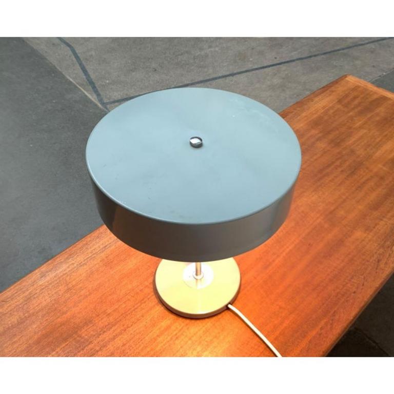Rare mid century table lamp of the Hungarian company Szarvasi Vas-Fémipari.

A minimalist design. Functionalism from Soviet times. The lamp has a cylindrical screen made of metal. The shade is designed in gray and fixed with a chrome -colored screw.