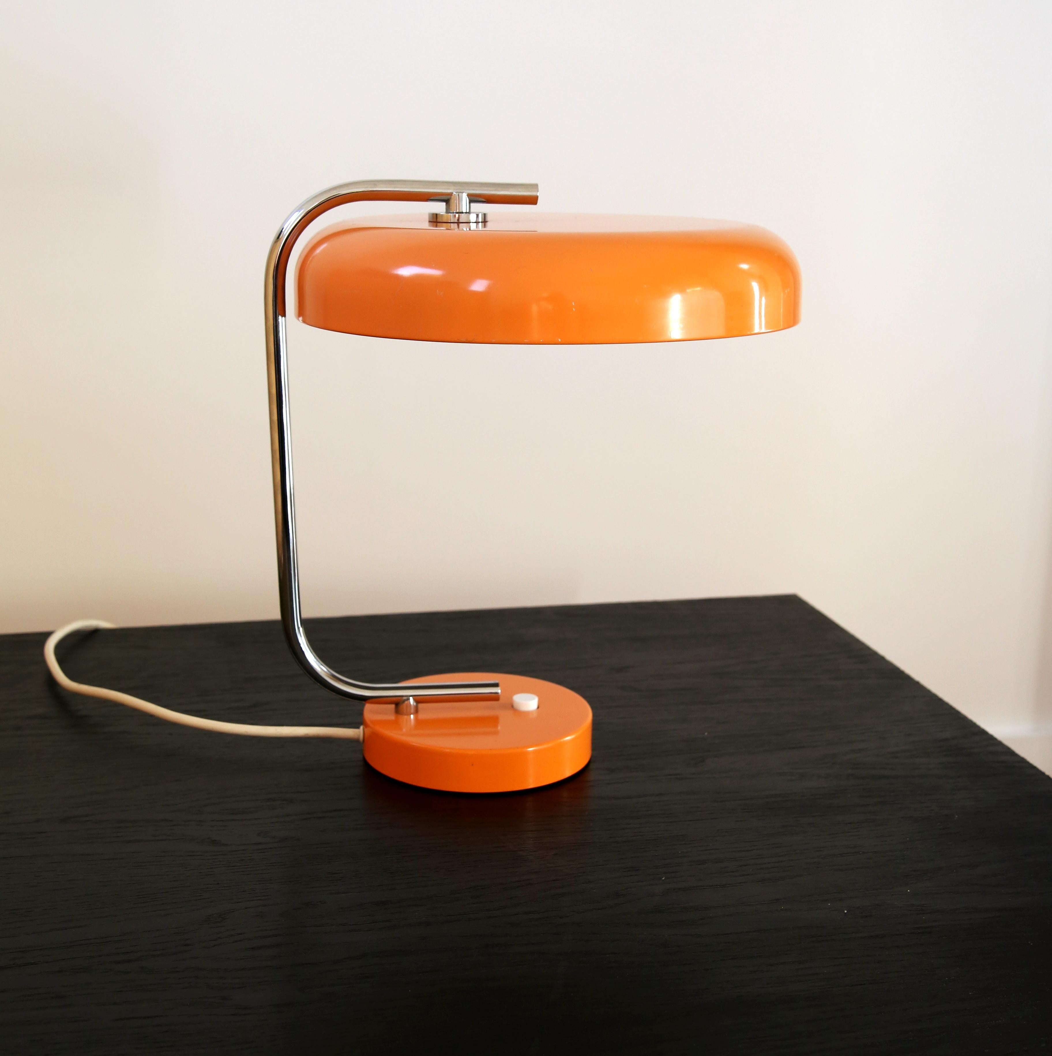 Stylish 60s desk lamp from Hustadt Leuchten in Germany in a pale orange colour, it's not a garish vibrant orange.
The simple and stylish design from the 1960s is very similar in design to Fase lamps.

The lamp consists of a base and shade in painted