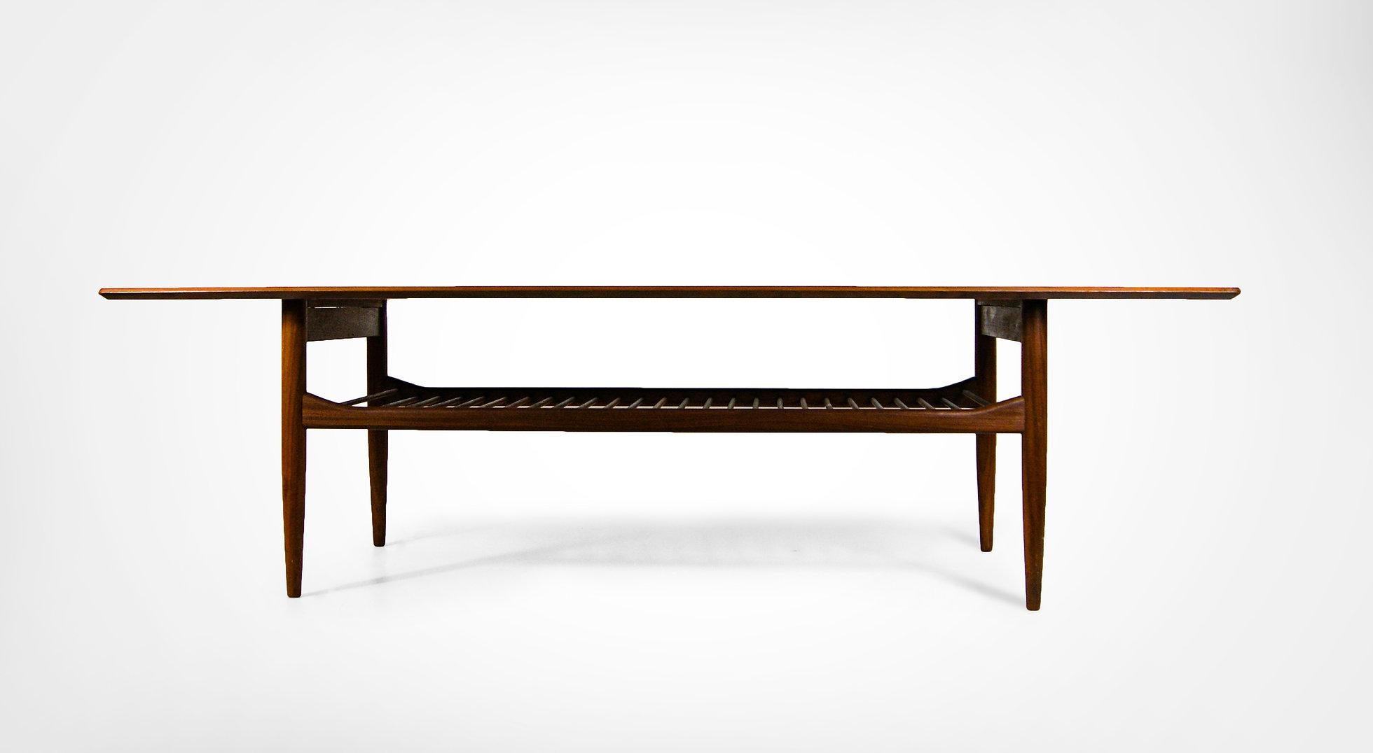 Mid-century large sized coffee table by Ib Kofod Larsen for G Plan.
Manufactured in the High Wycombe Buckinghamshire factory circa 1950s
Made of solid teak with beautiful patina.
Featuring a sleek chamfered detail to the edges.
With a magazine